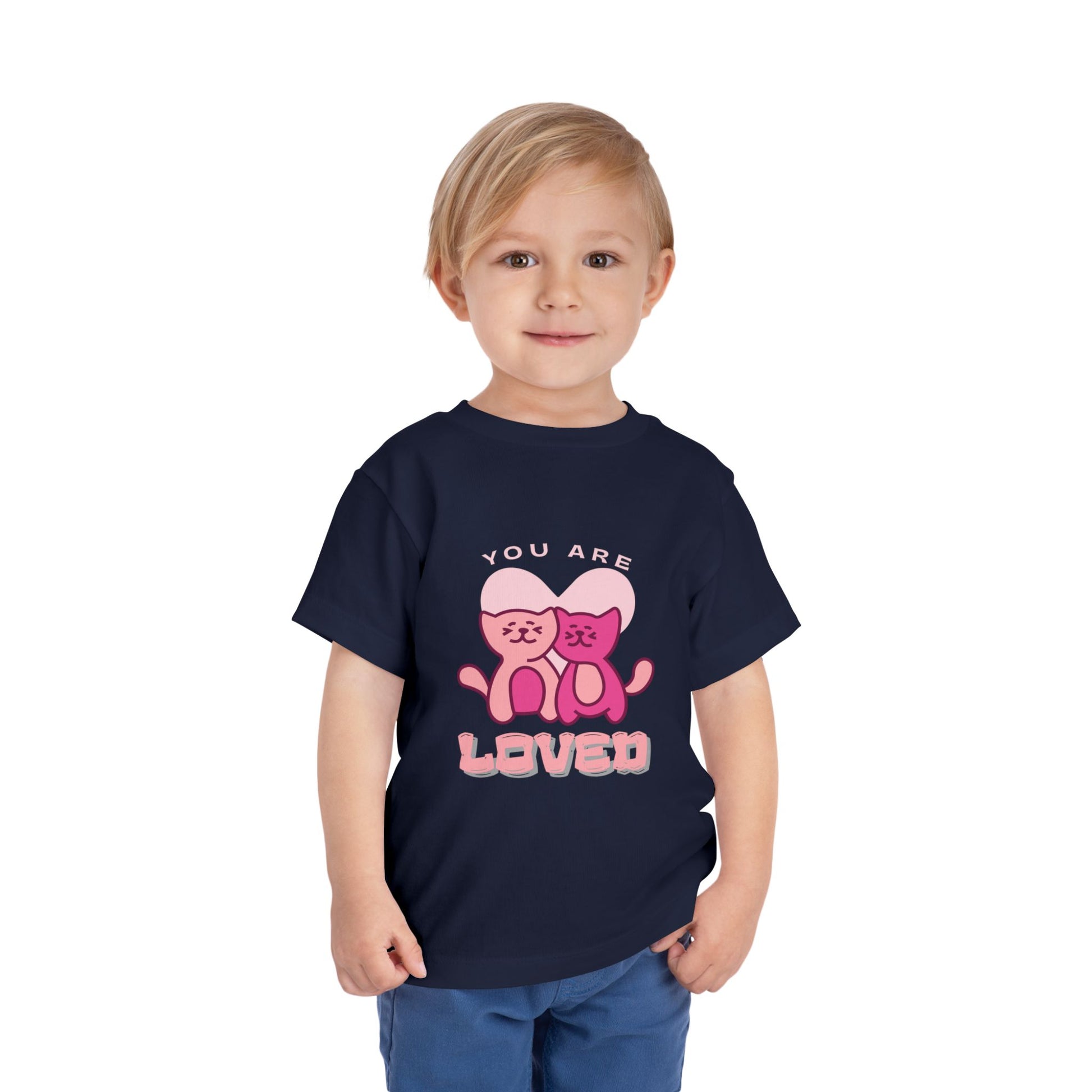 Child wearing a navy blue toddler t-shirt with two pink cats and 'You are loved' text 