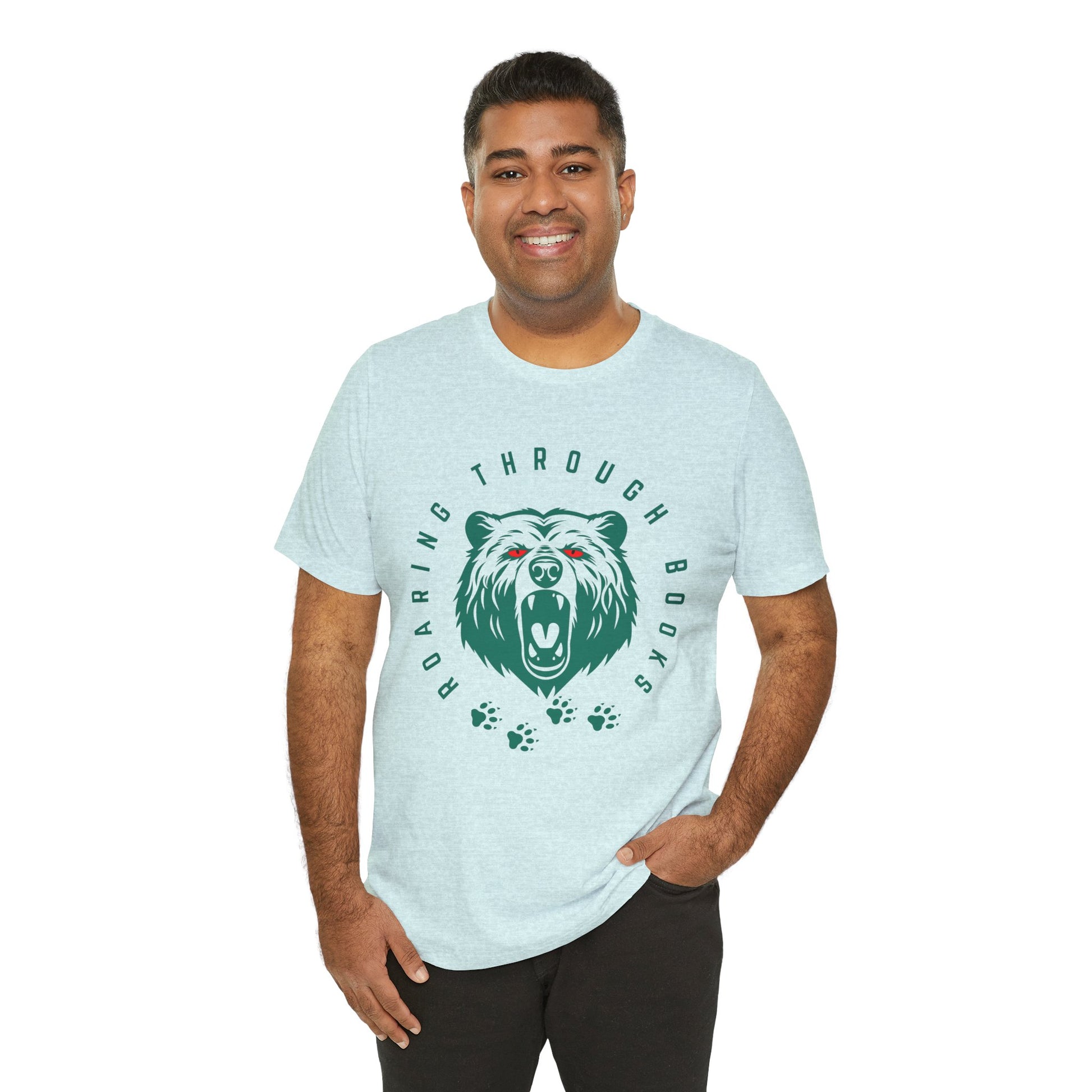 Man wearing a light ice blue t-shirt with a green bear graphic, red eyes and circular text 'Roaring Through Books'