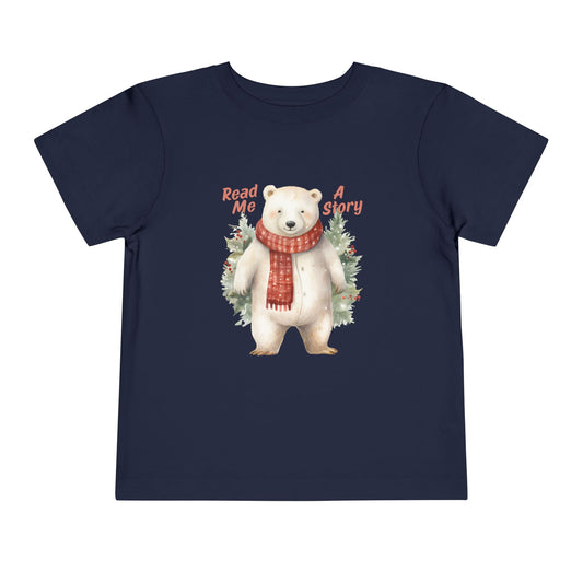 Navy blue toddler t-shirt with a polar bear wearing a scarf, surrounded by trees and text 'Read Me A Story' on a white background