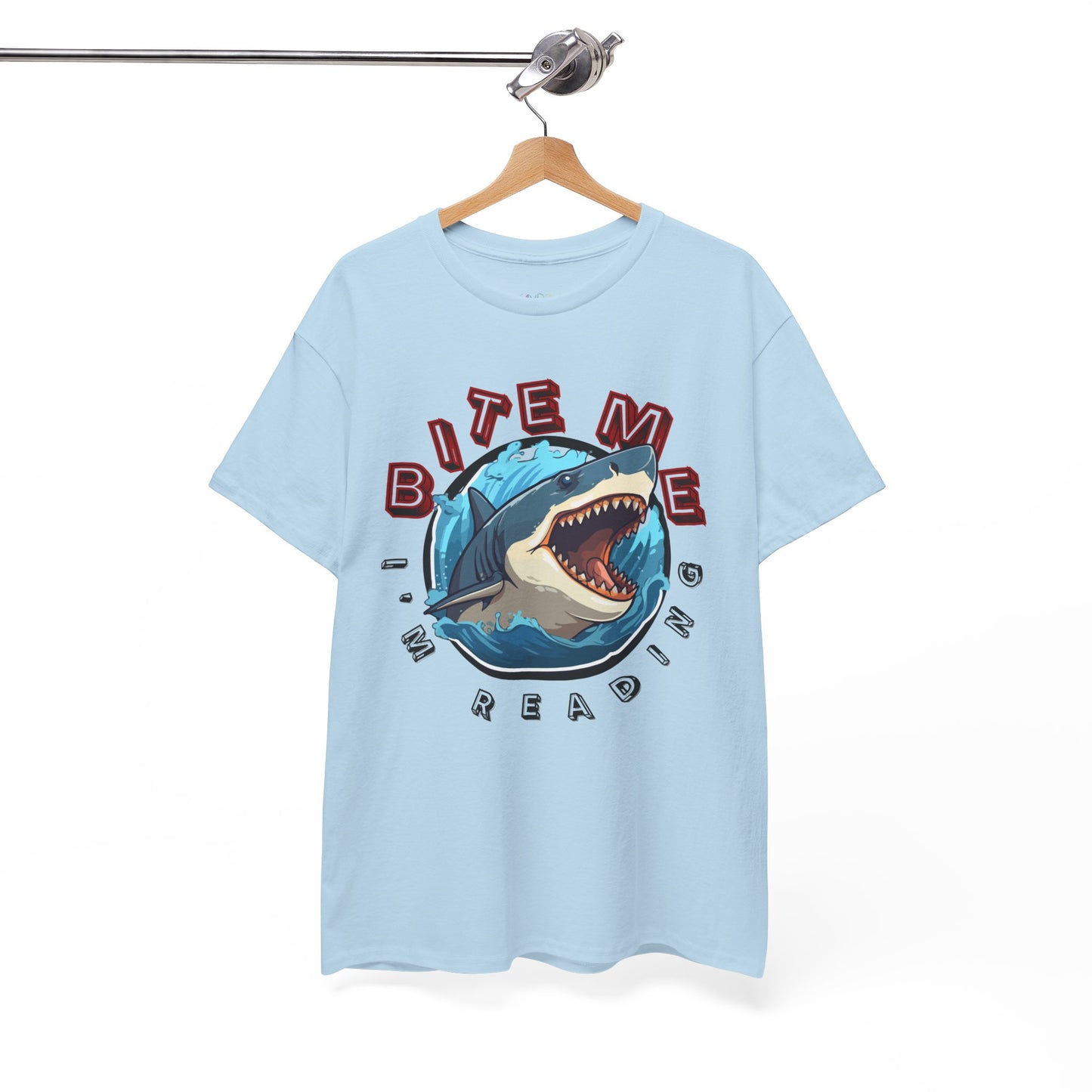 Light blue t-shirt with a shark graphic bursting out of the center and text 'Bite Me I'm Reading' 