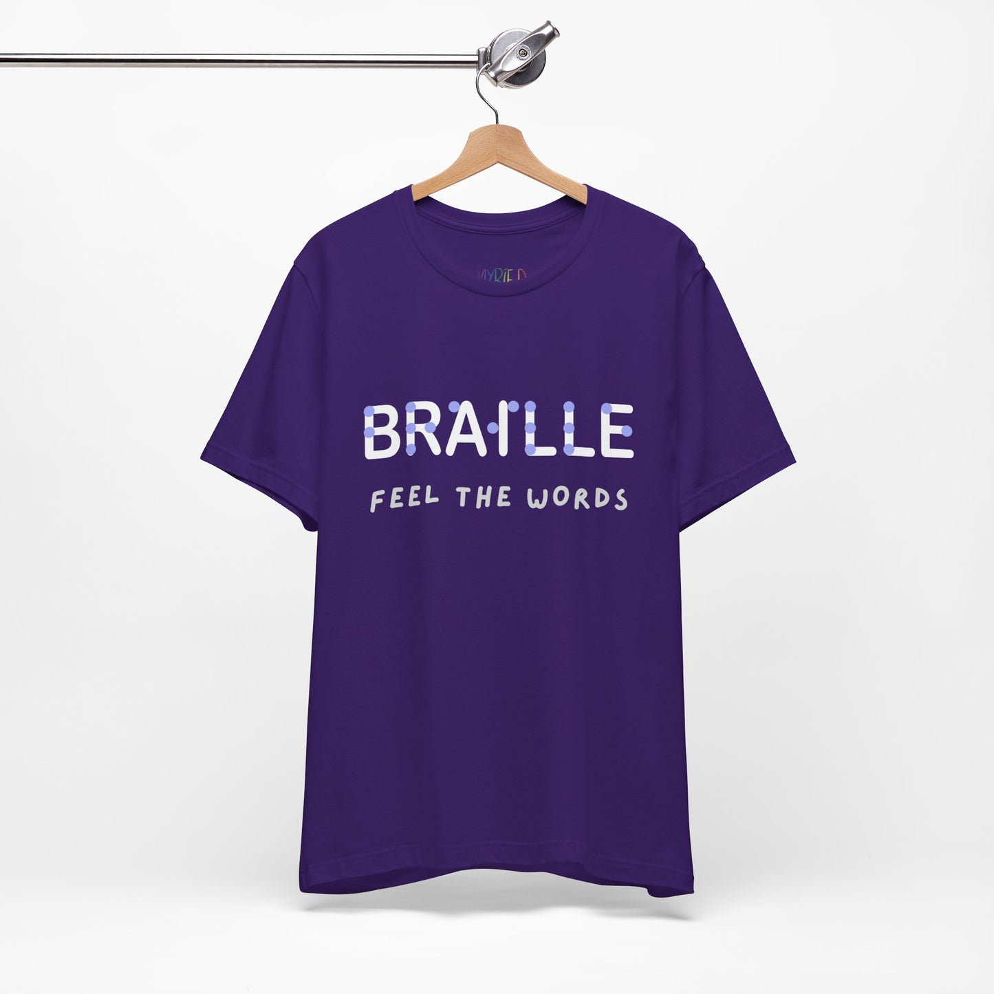 Purple t-shirt with light purple and white text 'Braille Feel the Words' 