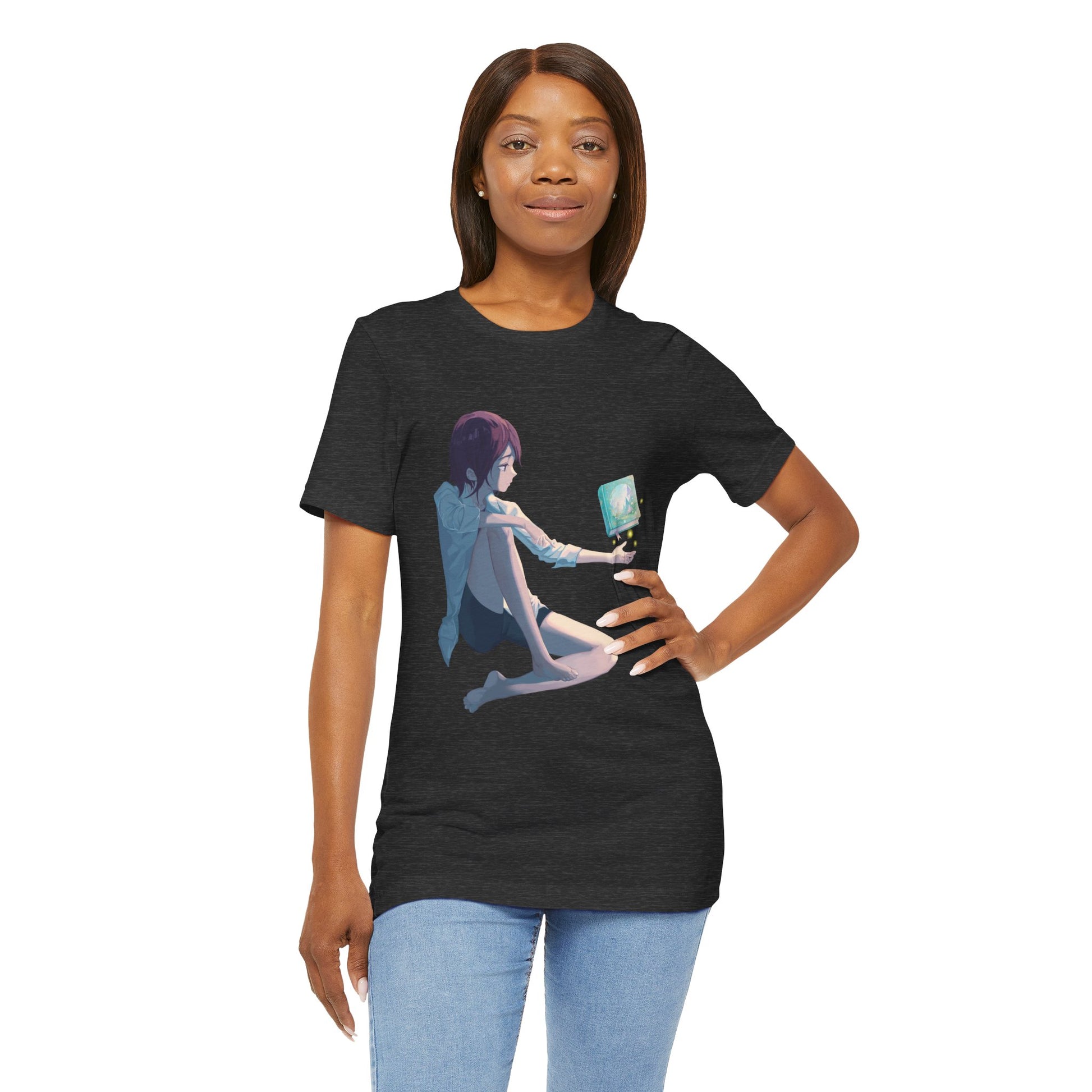 Woman wearing a dark gray t-shirt with a fantasy illustration of a person holding their palm up as a book magically floats above it