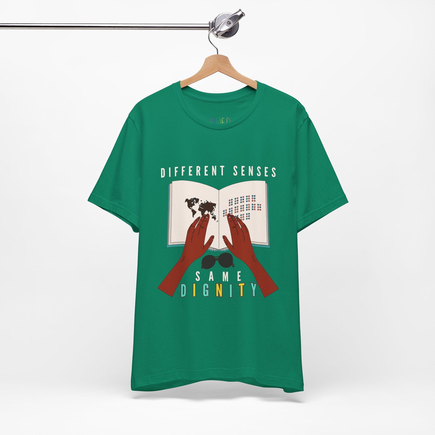 Green t-shirt with graphic of two hands touching a braille book and text 'Different Senses, Same Dignity'