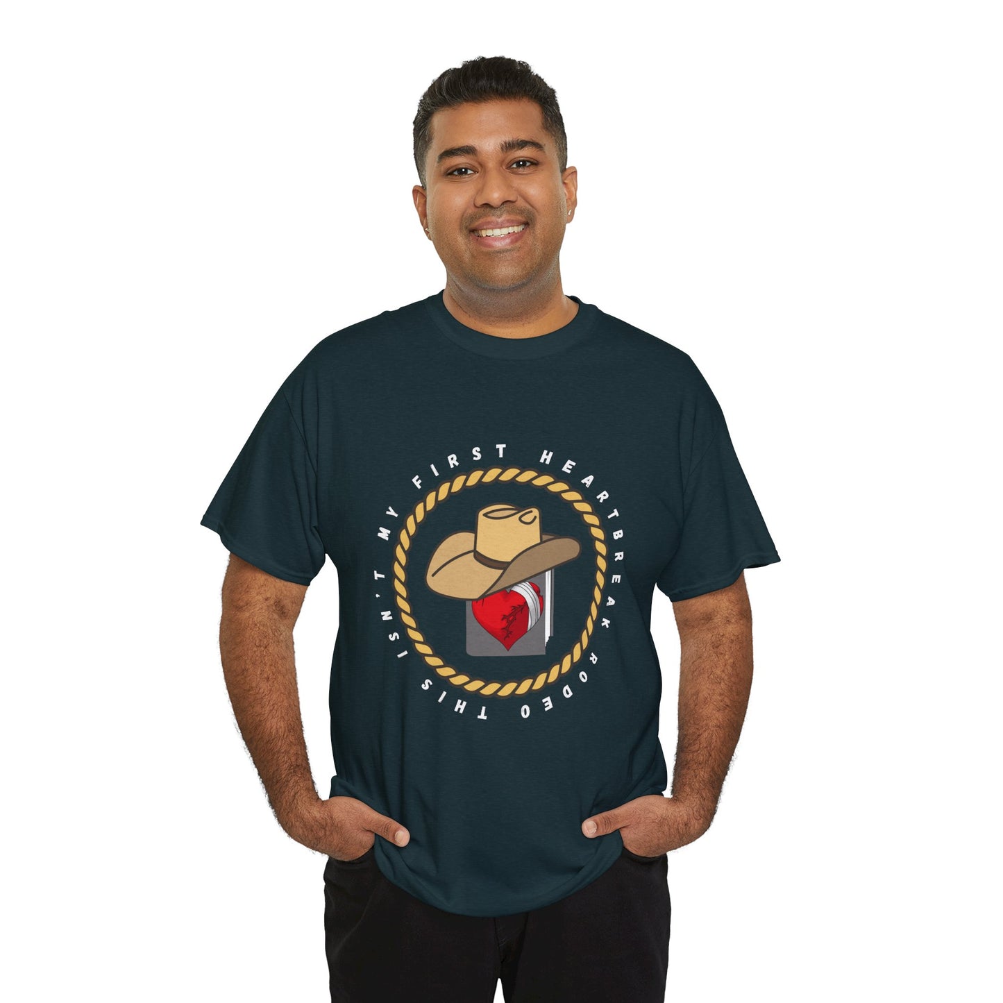 Man wearing a dark t-shirt with a cowboy hat atop a book with a broken heart, circled by a rope and text 'This Isn't My First Heartbreak Rodeo'