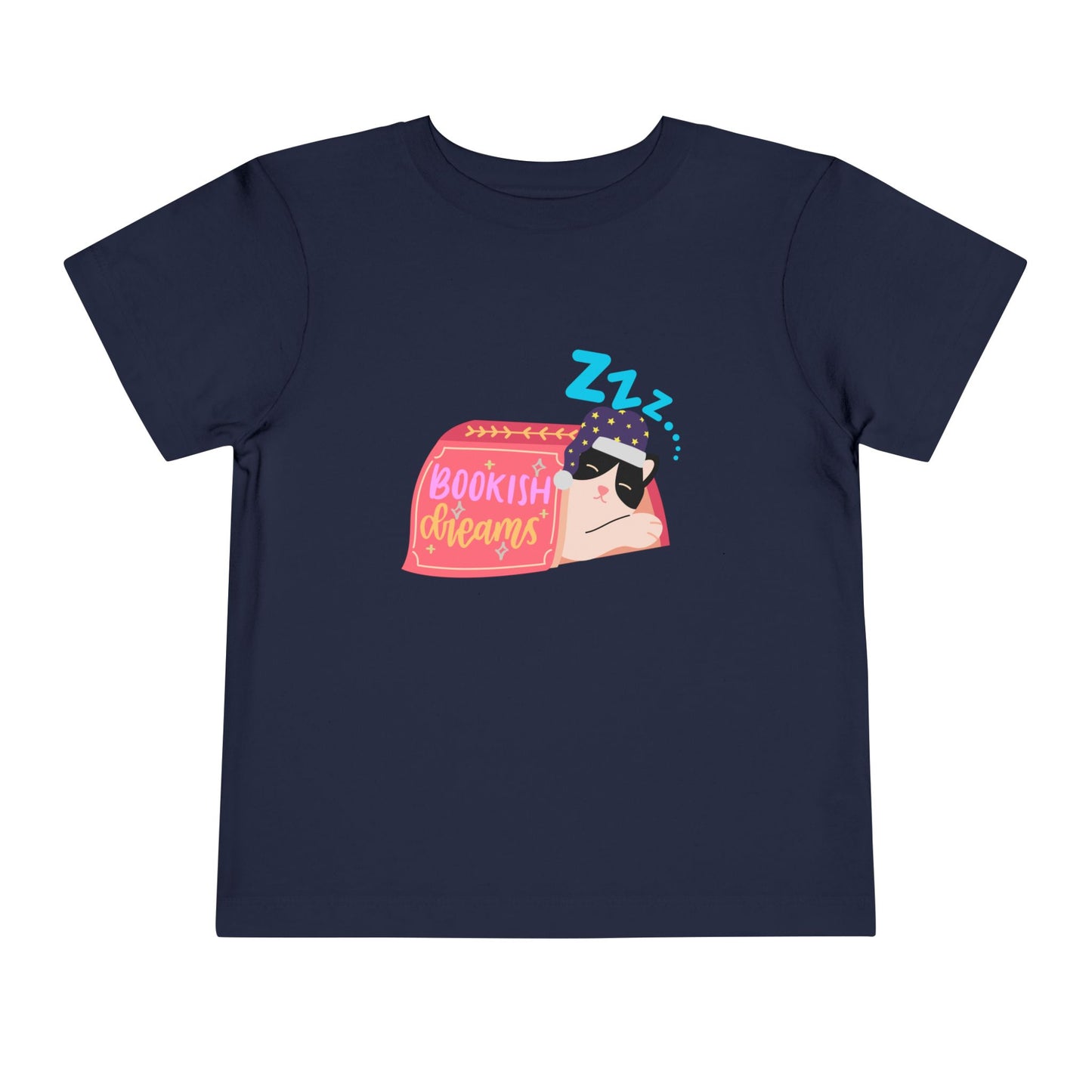 Navy blue toddler t-shirt with a snoozing cat in a night cap, under a book and text 'Bookish Dreams' 