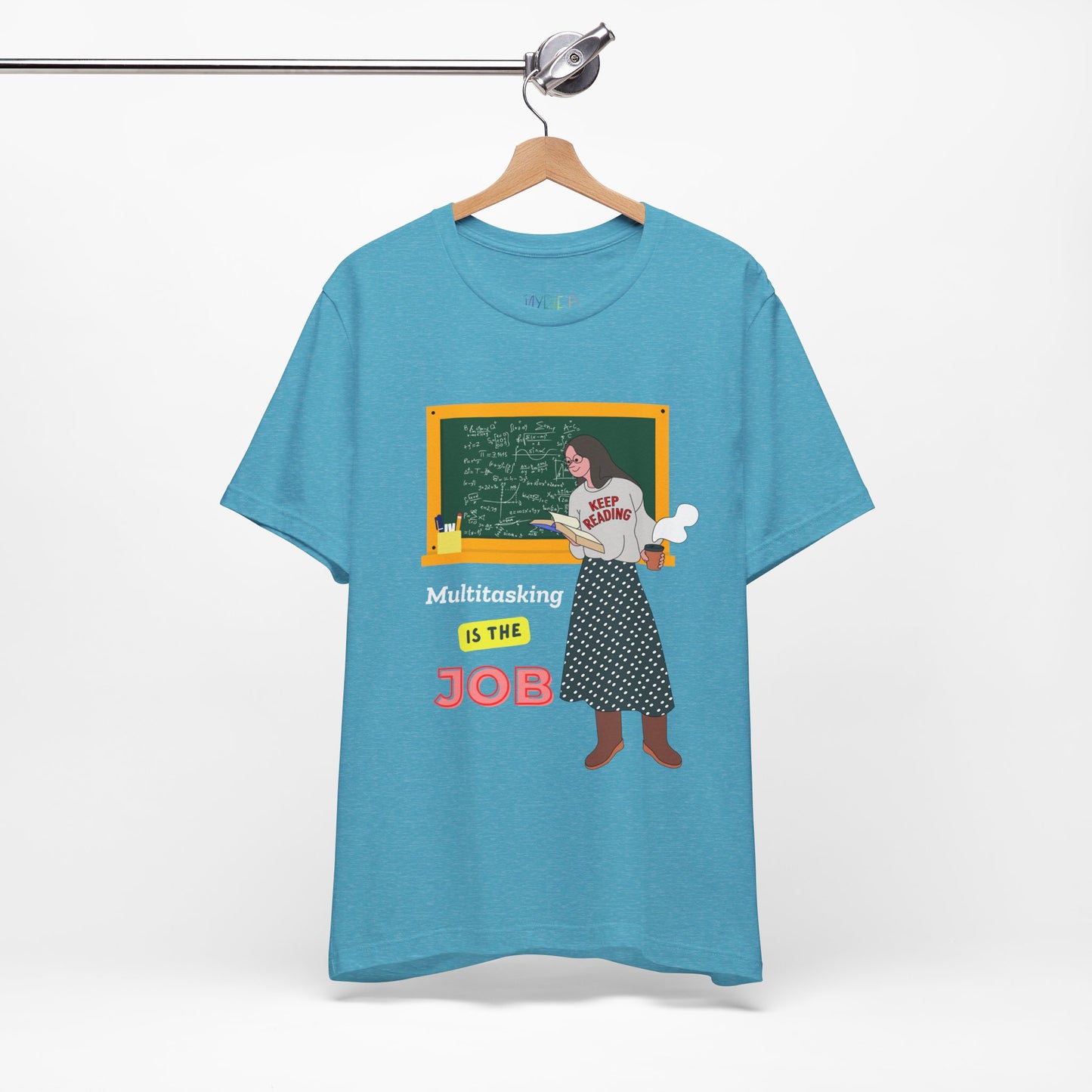 Turquoise t-shirt with a graphic design of a woman at a chalkboard, an open book in one hand and steaming coffee in the other, text 'Multitasking is the Job' 