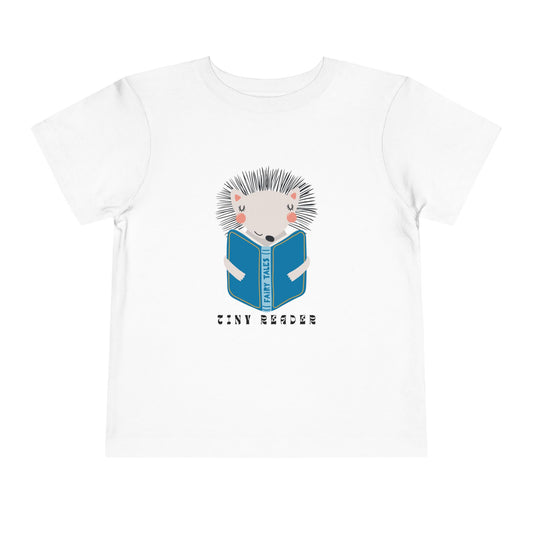 White t-shirt with a hedgehog reading a book graphic and 'Tiny Reader' text