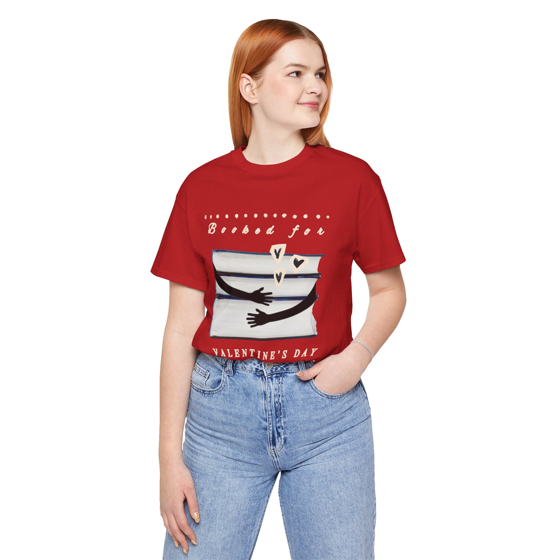 Woman wearing a red t-shirt with a graphic design featuring arms hugging a stack of books and text 'Booked for Valentine's Day' 