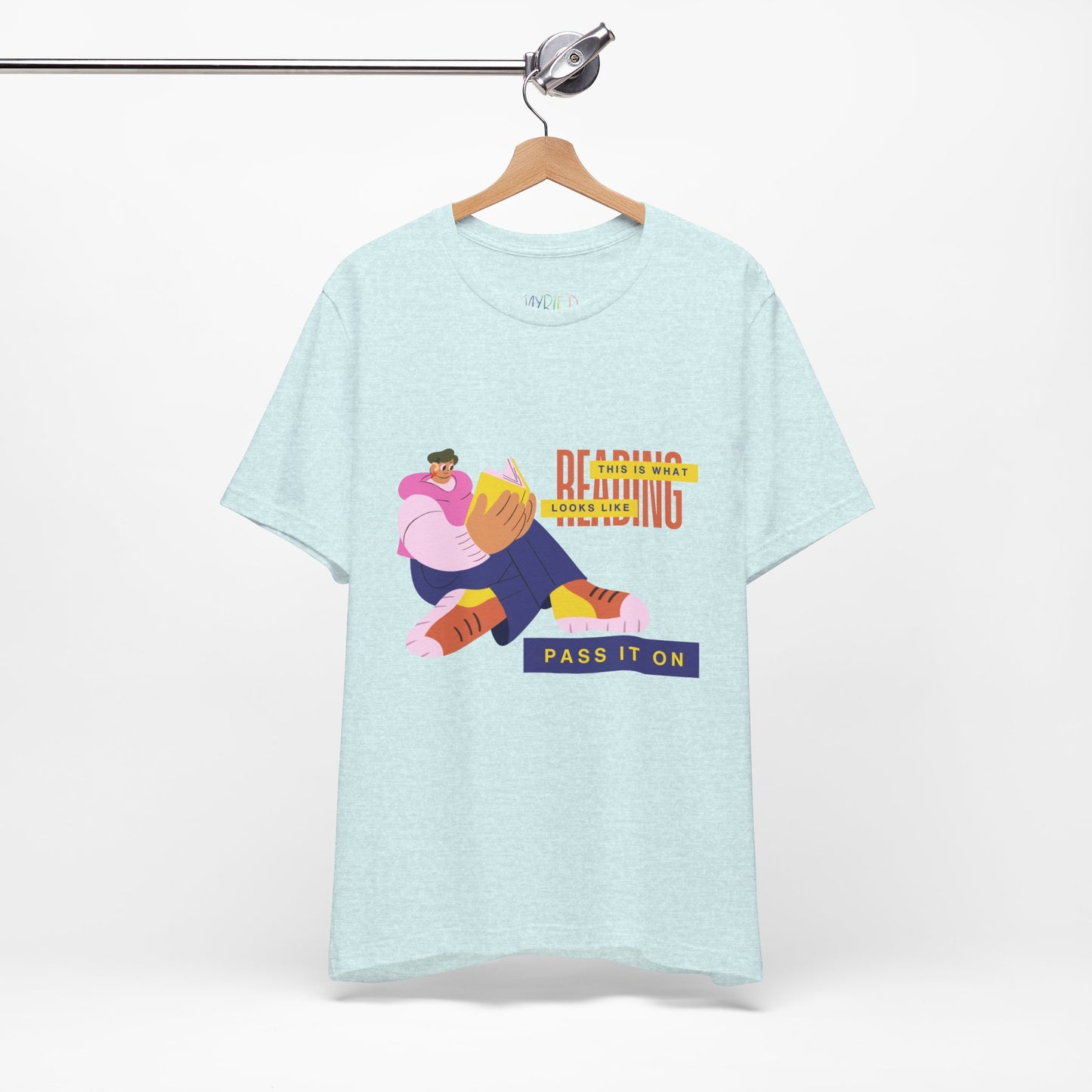 Light ice blue t-shirt with colorful, funny shaped figure reading a book and text 'This Is What Reading Looks Like, Pass It On'