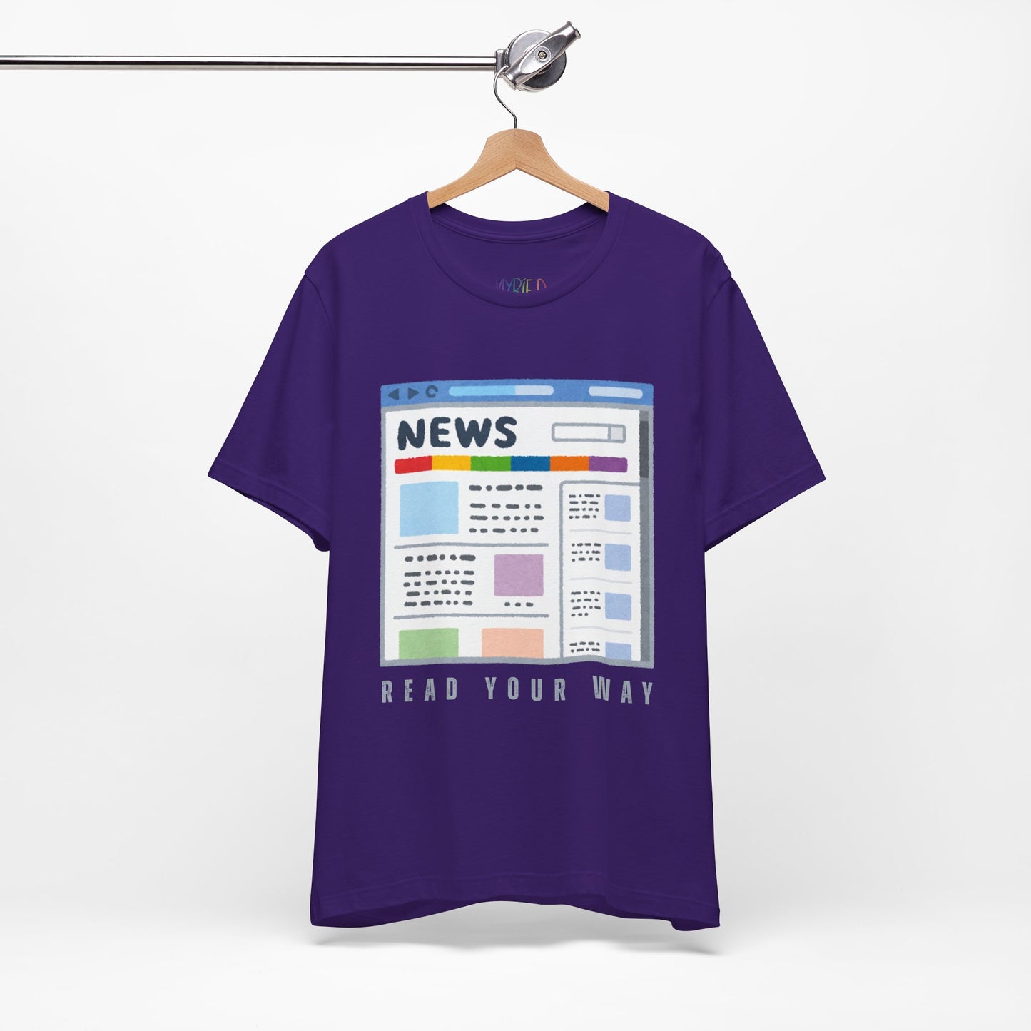 Purple t-shirt with a graphic of a news website and text 'Read Your Way' 