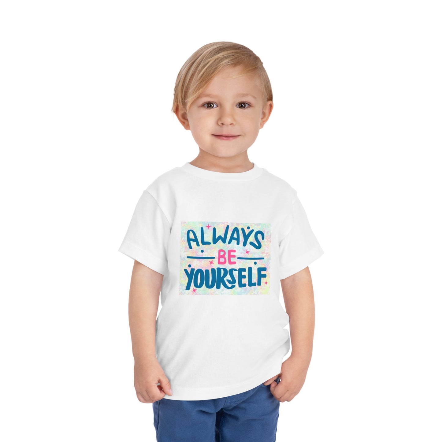Child wearing a toddler t-shirt featuring text 'Always Be Yourself' with a colorful pastel background