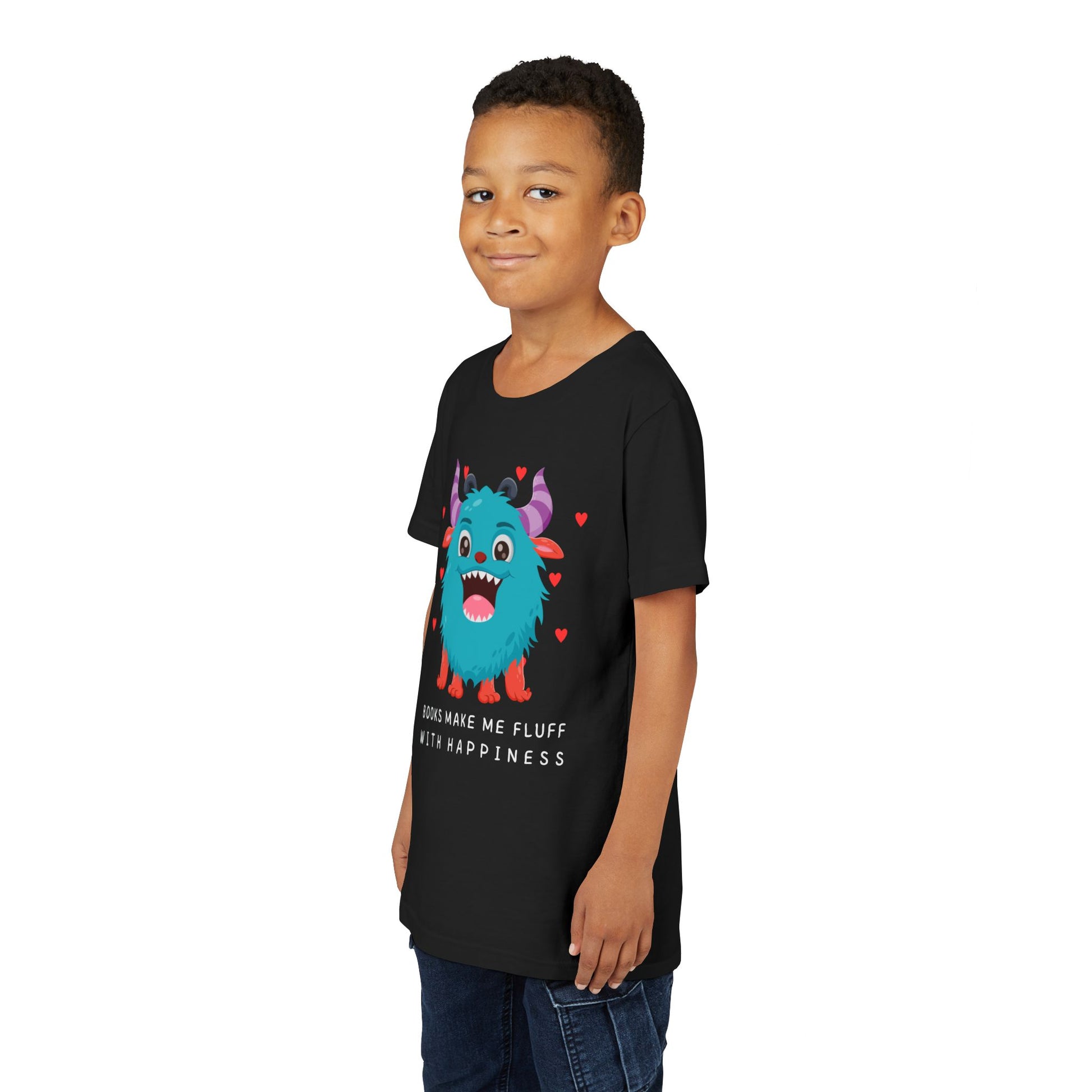 Boy wearing a black t-shirt with a joyful cartoon monster surrounded by hearts and text 'Books Make Me Fluff With Happiness'