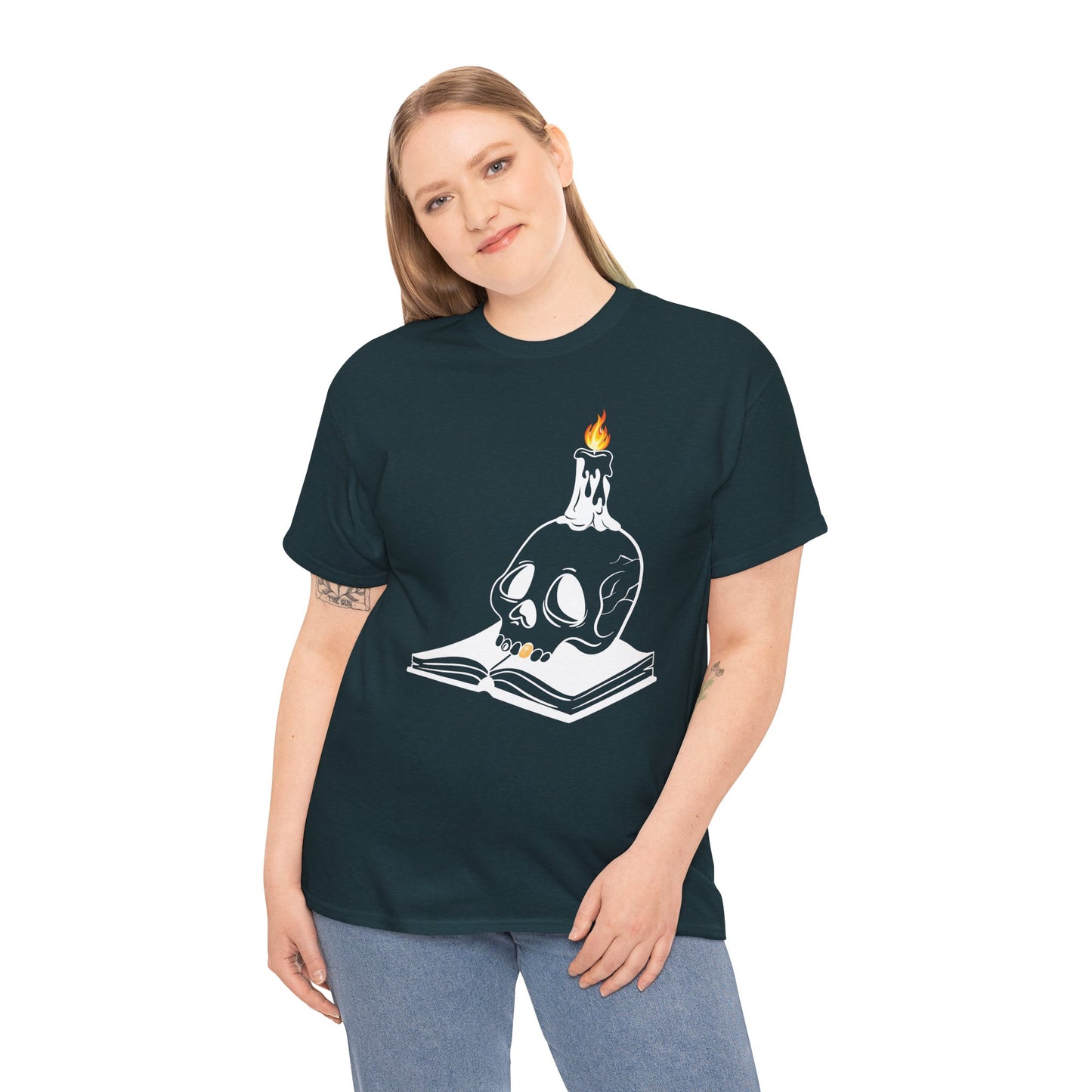Woman wearing a midnight t-shirt with a graphic design of a skull and candle on an an open book