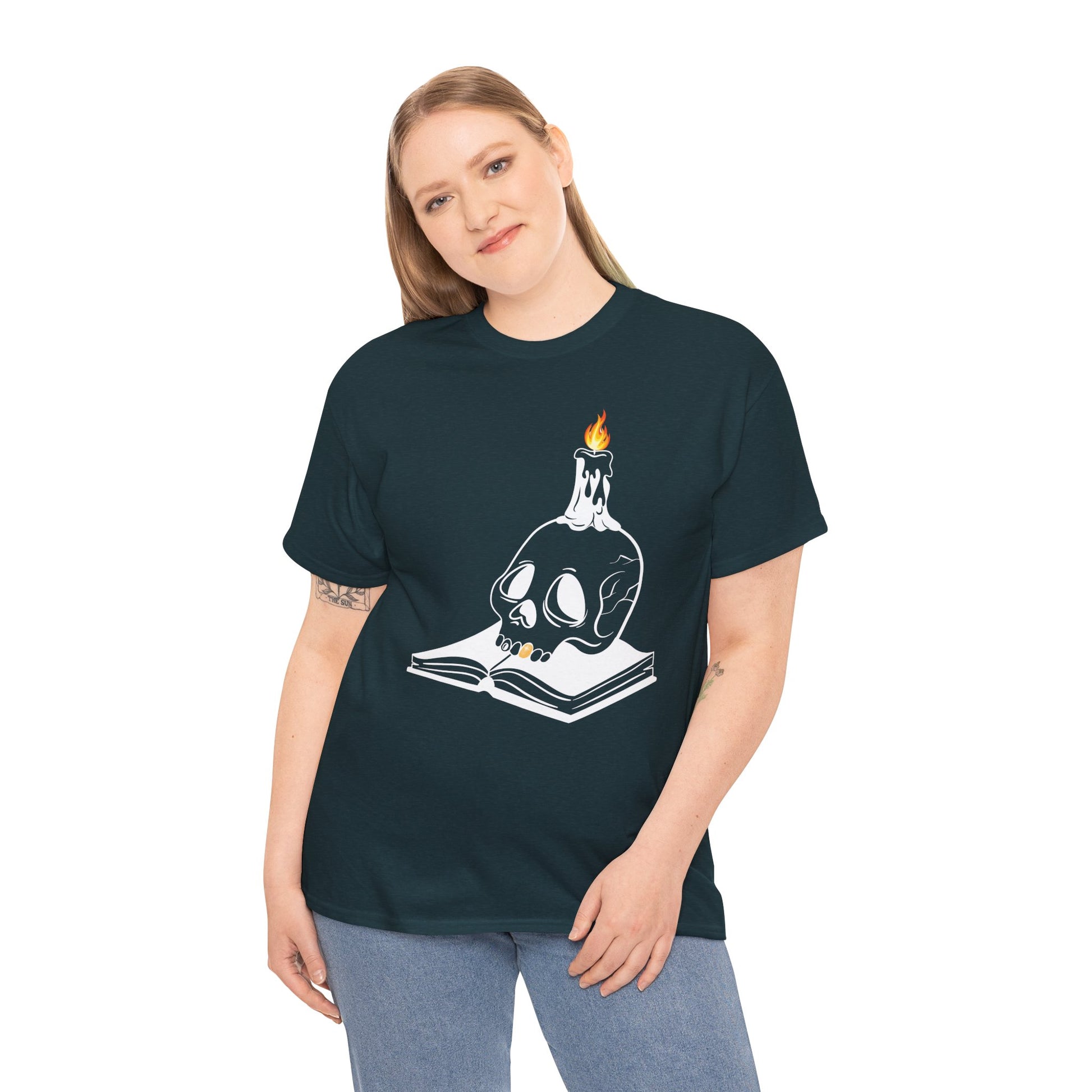Woman wearing a midnight t-shirt with a graphic design of a skull and candle on an an open book