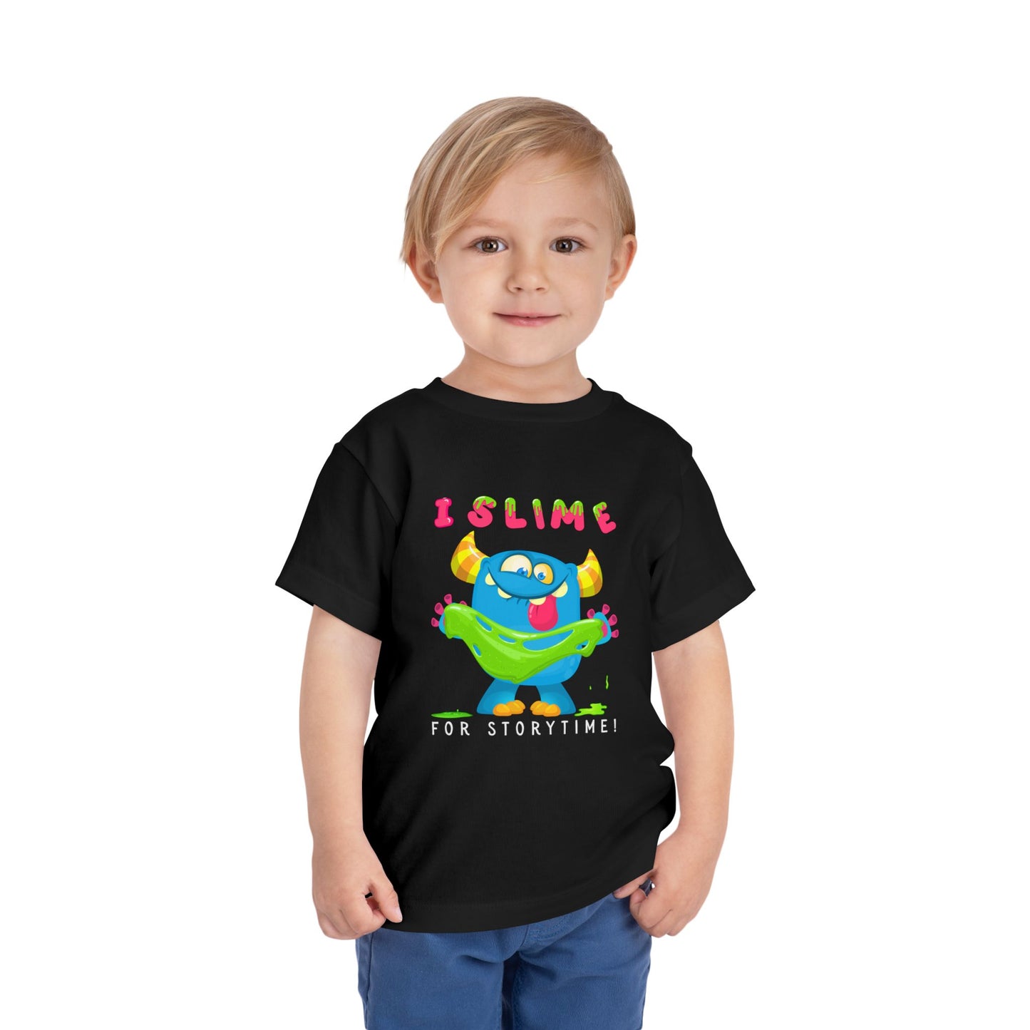 Child wearing a black toddler t-shirt with a colorful monster graphic holding green slime and playful text 'I SLIME FOR STORYTIME!'
