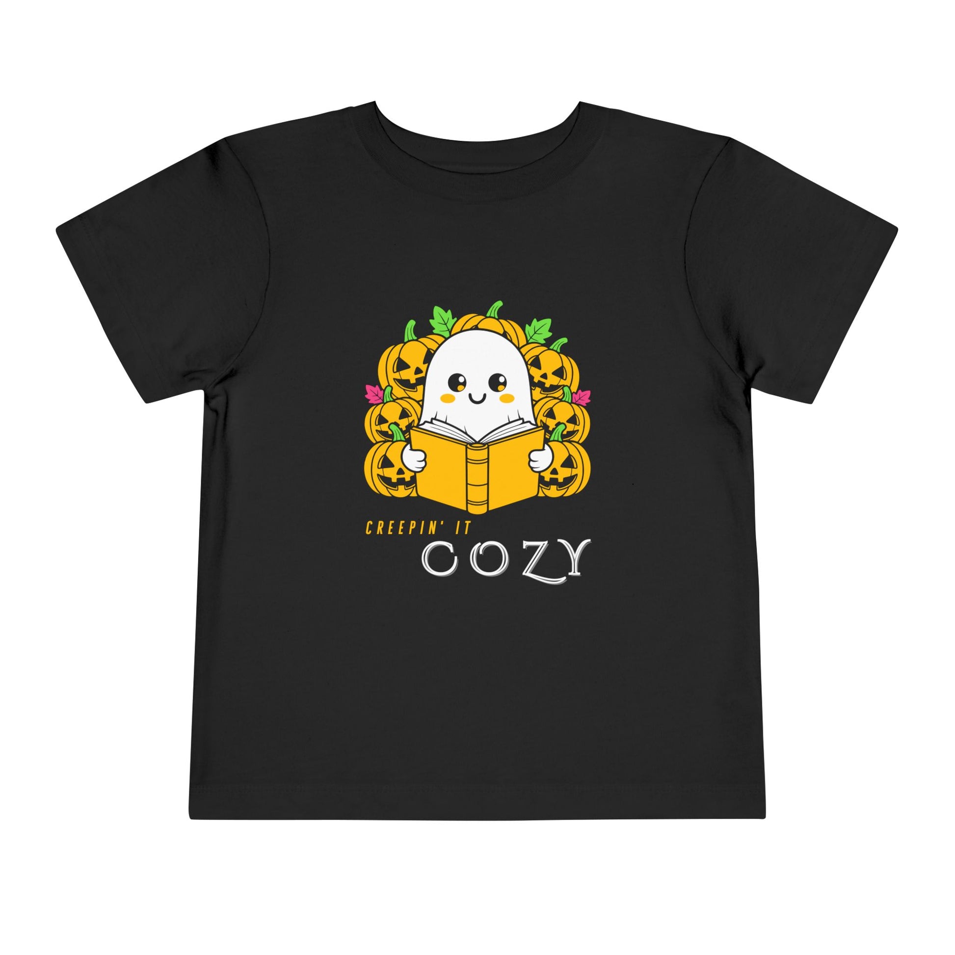 Black toddler t-shirt with a ghost reading a book in pumpkin patch and text 'Creepin' It Cozy'