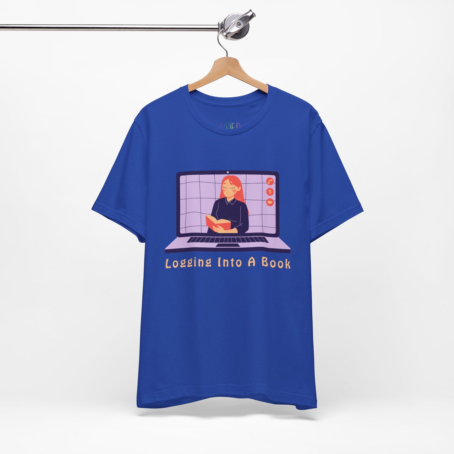 Blue t-shirt with open laptop featuring a woman reading a book and text 'Logging Into A Book' 