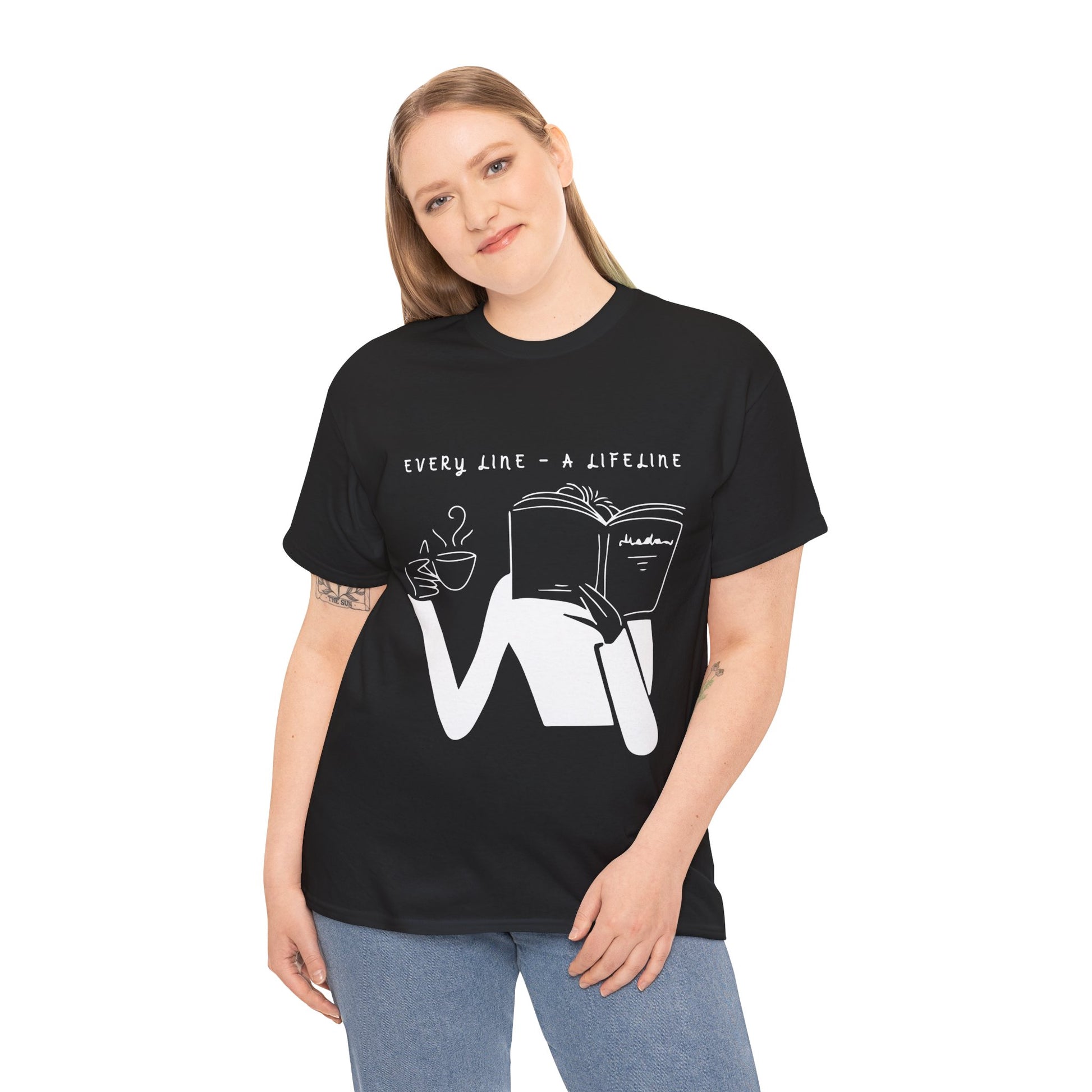 Woman wearing a black t-shirt with white graphics of someone holding up a hot beverage and a book as they read, text 'Every Line - A Lifeline' 