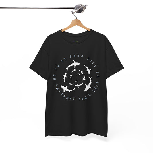 Black t-shirt with white graphic sharks in various sizes circling and text 'circling my to be read pile be like this' 