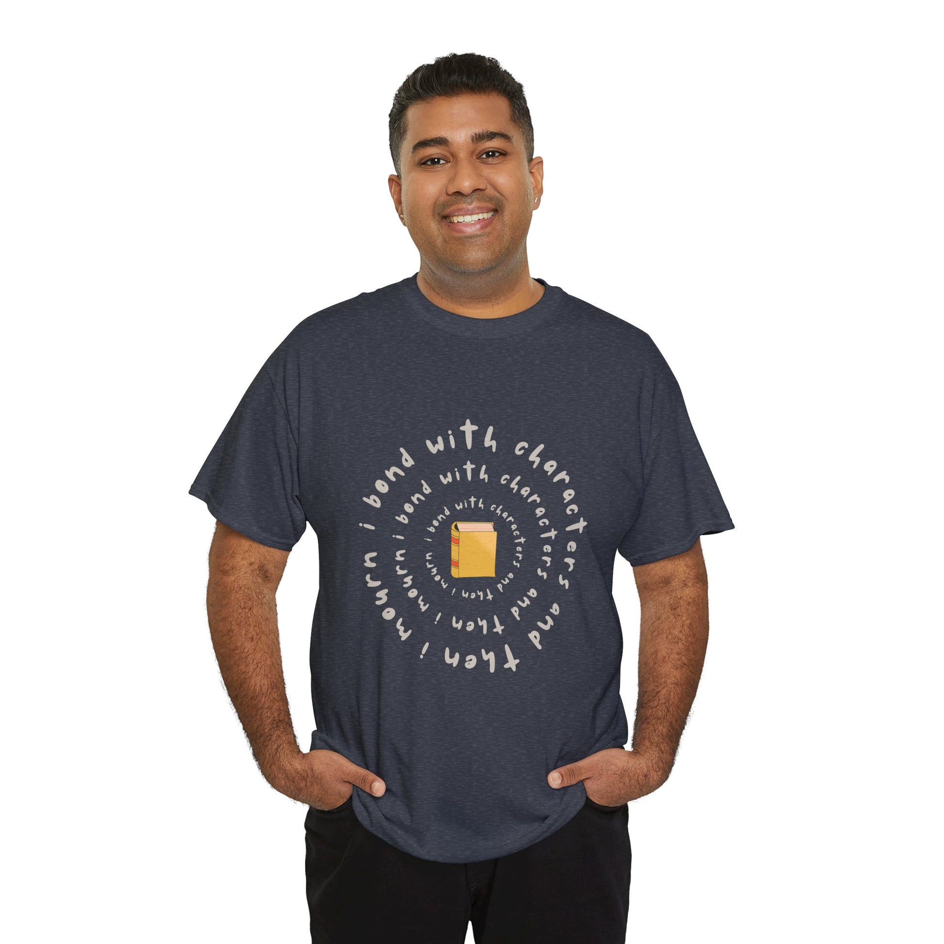 Man wearing a heather navy blue t-shirt with a small book at the center and layered spiral text 'I Bond With Characters & Then I Mourn'