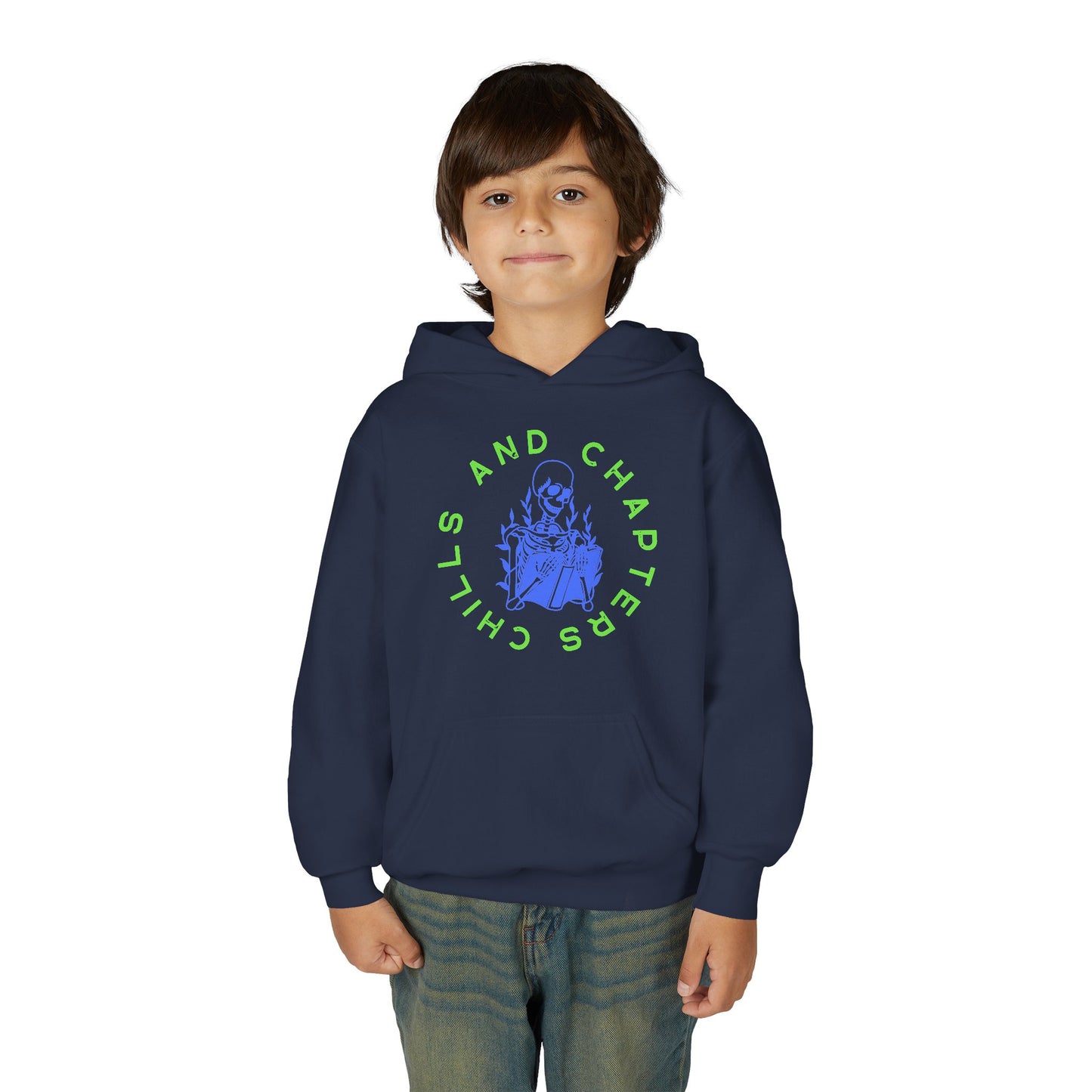 Boy wearing a navy blue hoodie with a skeleton reading a book graphic design and circular text 'CHILLS AND CHAPTERS'