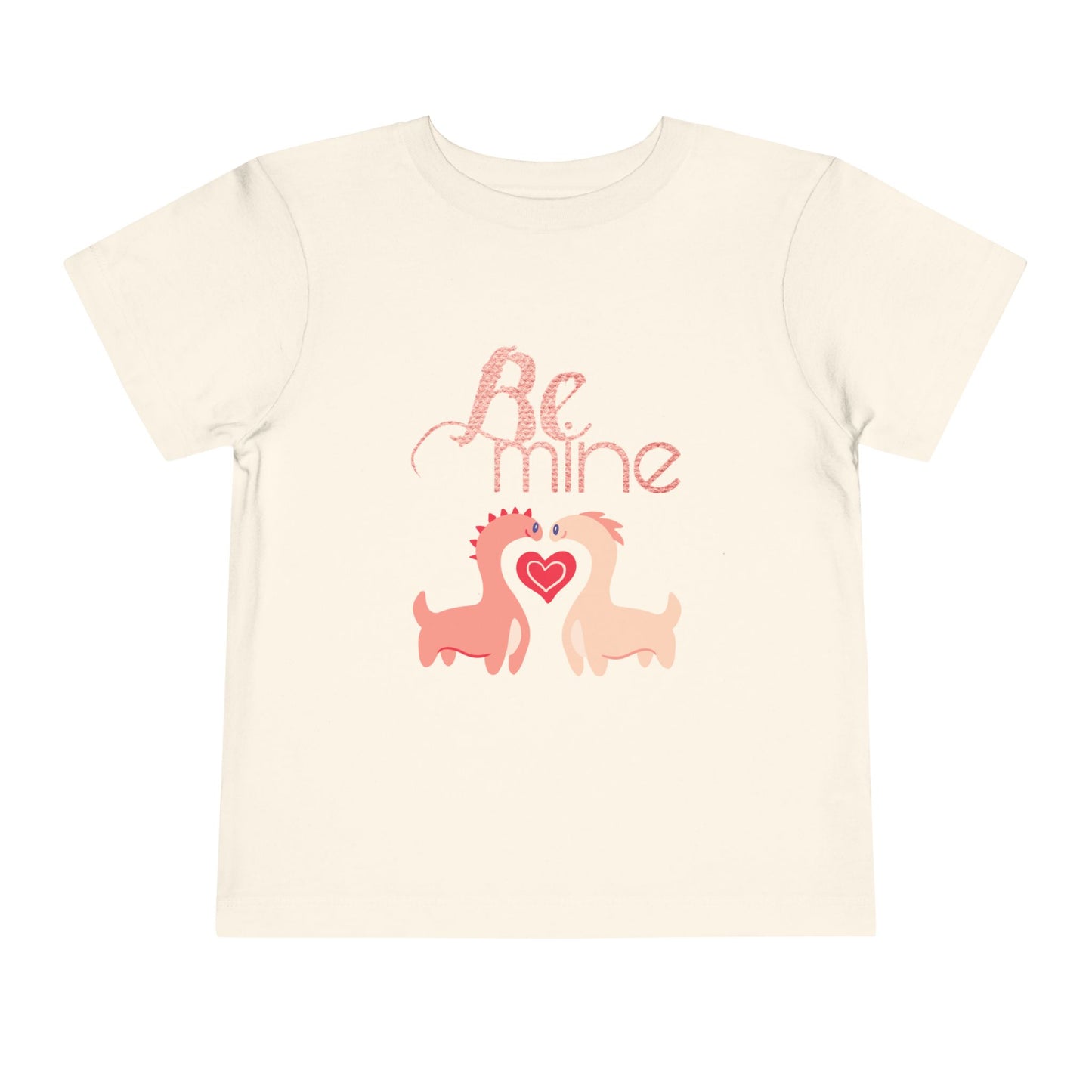 Beige toddler t-shirt with two pink dinosaurs, a heart and 'Be Mine' text 
