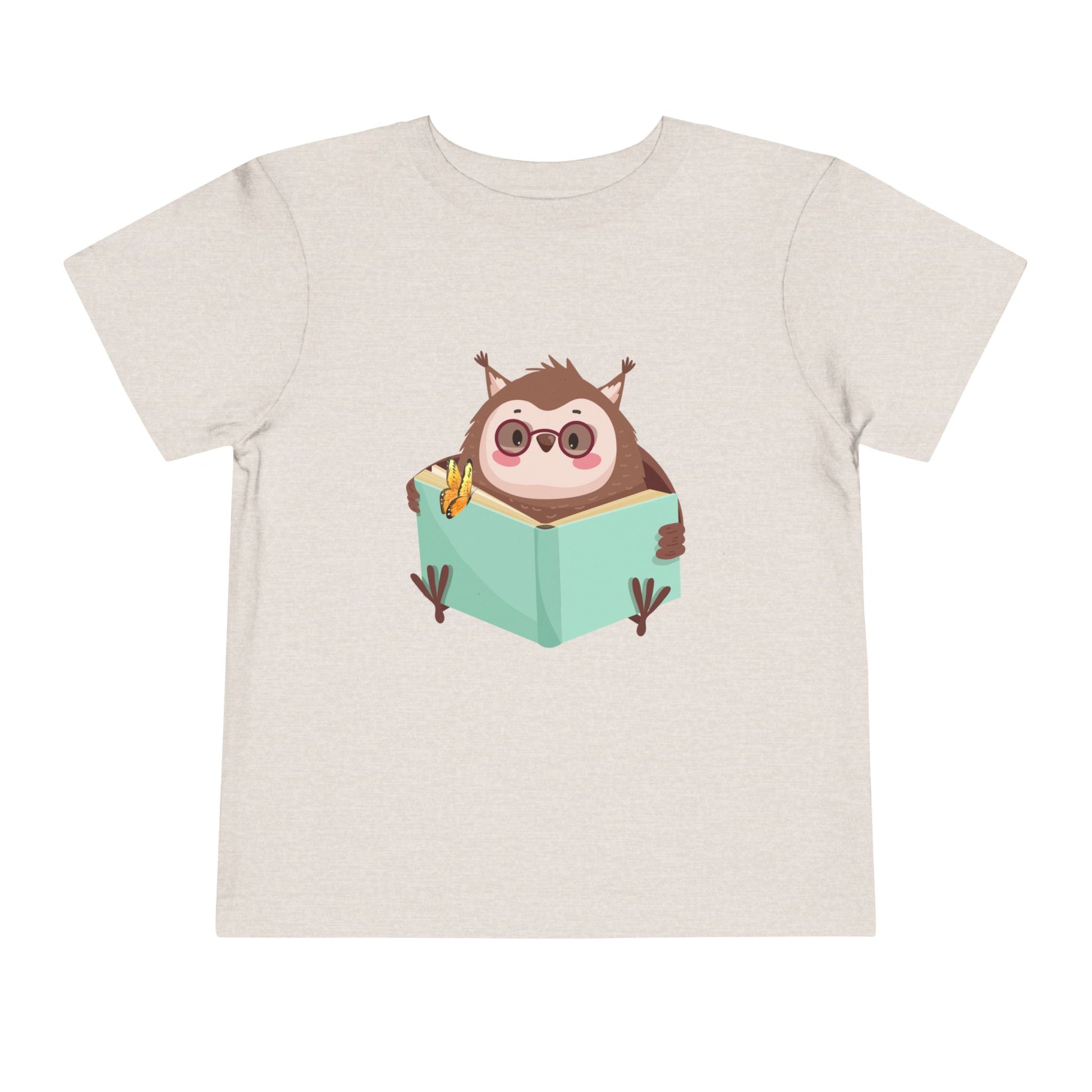 Beige toddler t-shirt with a cartoon own reading a book with a butterfly perched on top