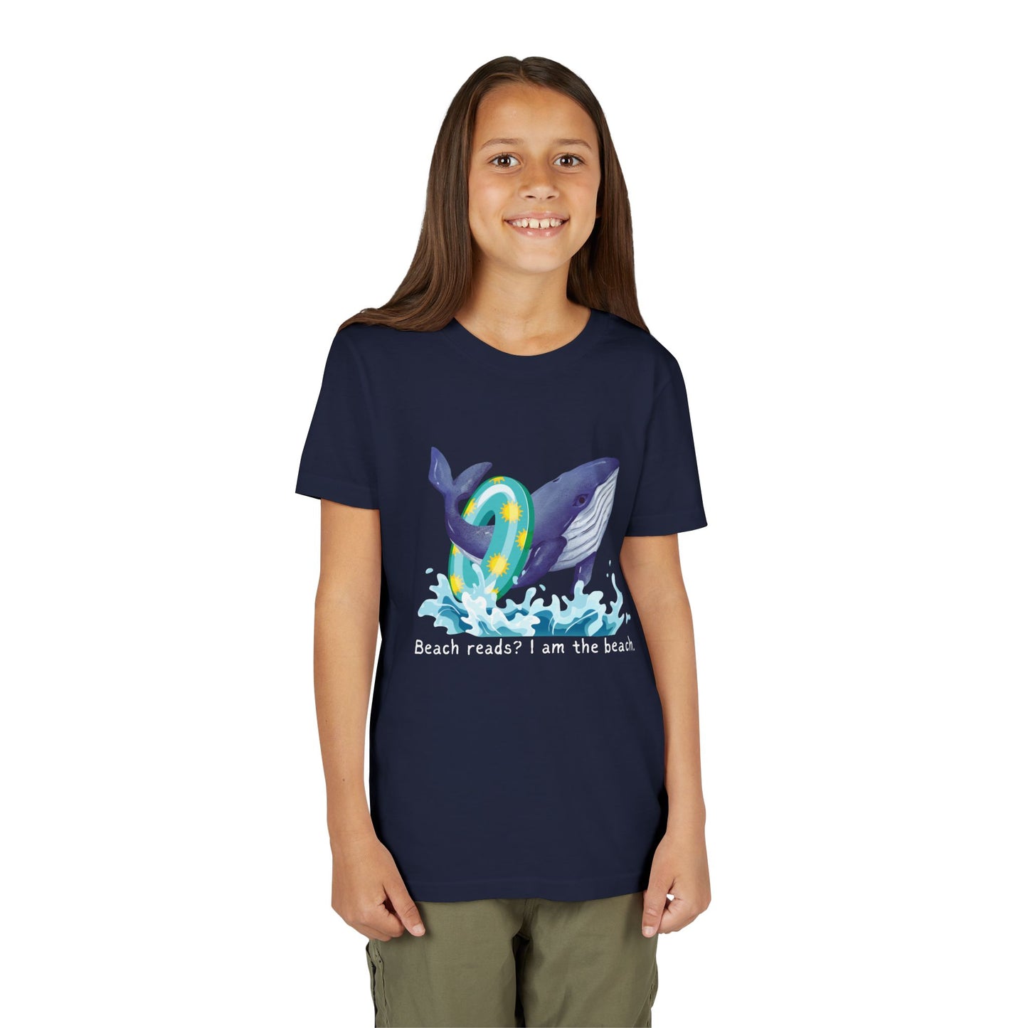Girl wearing a navy blue t-shirt with a whale wearing a pool floaty ring and text 'Beach reads? I am the beach.'