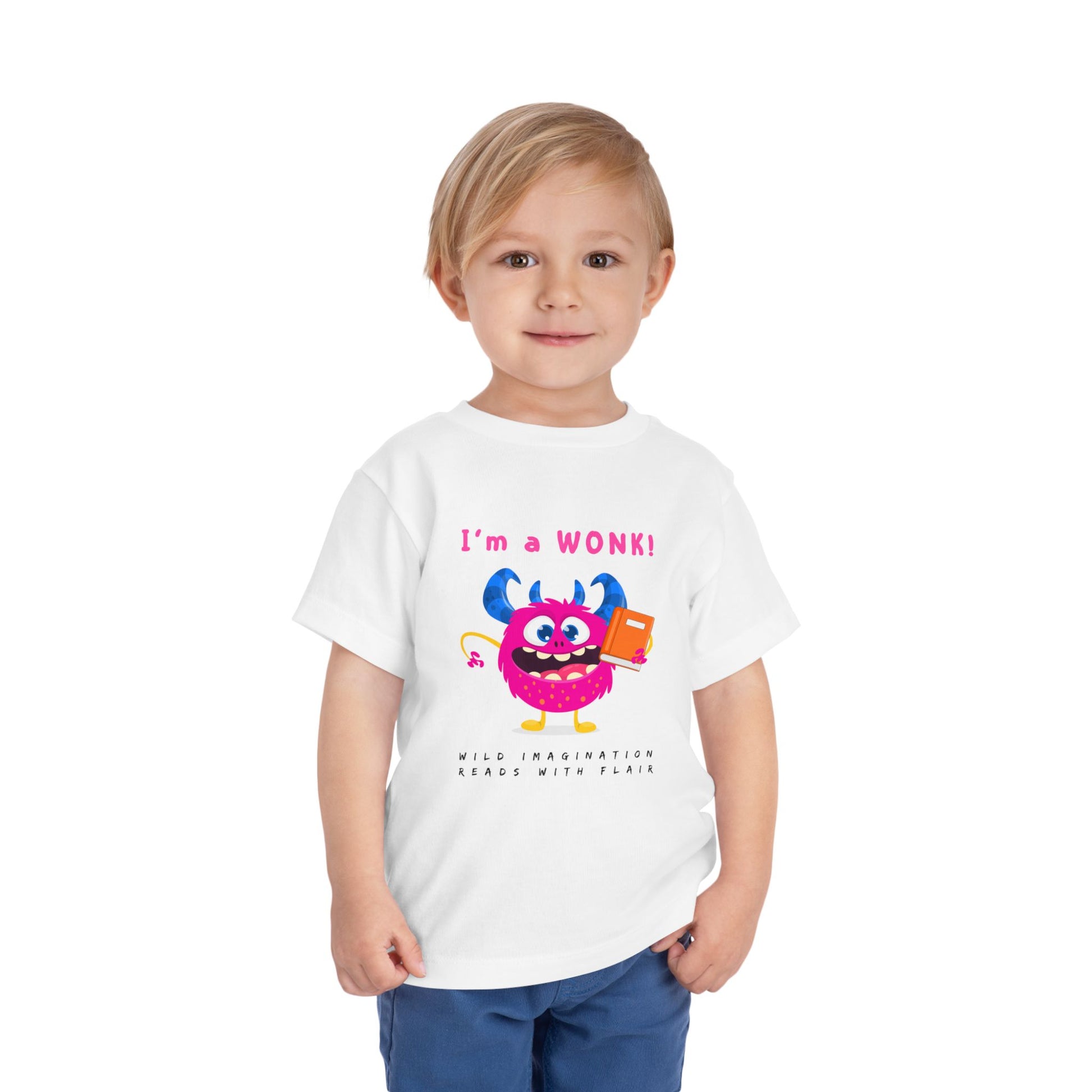 Child wearing a white toddler personality t-shirt with a cartoon monster holding a book, proudly proclaiming 'I'm a WONK!' Sub-text 'Wild Imagination, Reads With Flair' on a white background
