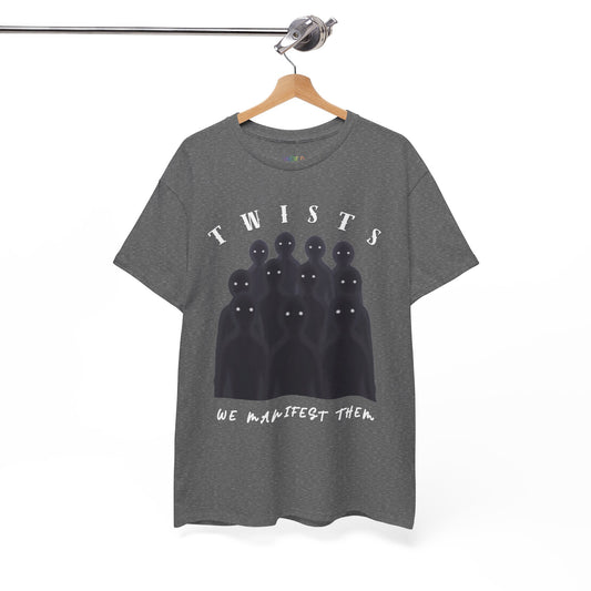 A dark heather gray t-shirt hanging on a wooden hanger from a metal rail, featuring a graphic of eleven black ghostly figures with white eyes under the word 'TWISTS' and above the phrase 'WE MANIFEST THEM'.