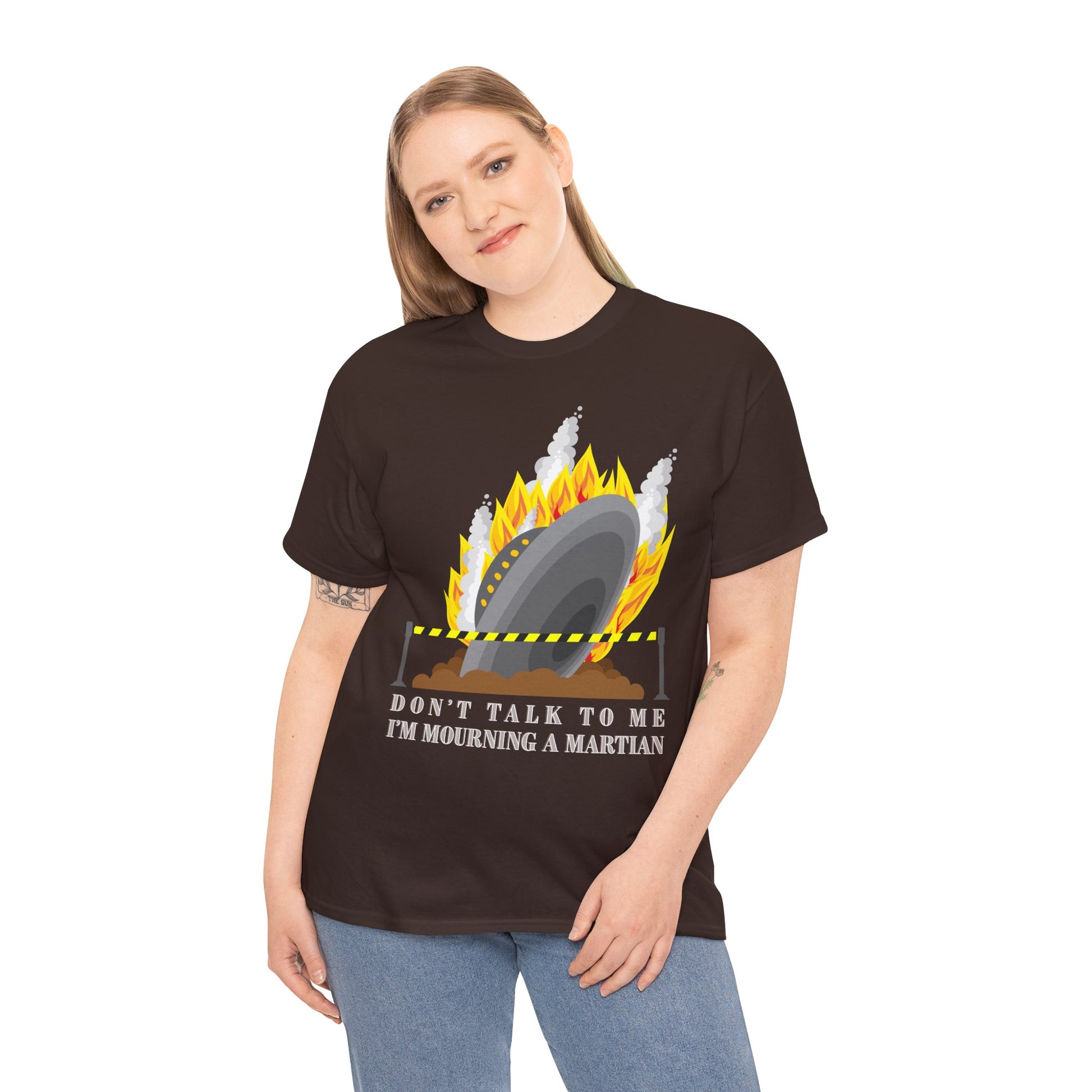 Woman wearing a brown t-shirt with a crashed spaceship blocked by caution tape and text 'Don't Talk To Me I'm Mourning A Martian' 