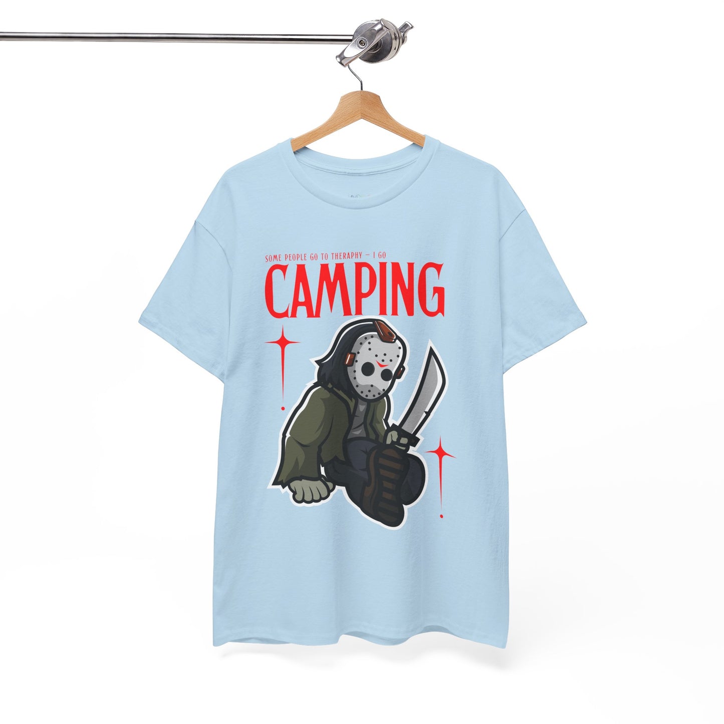 Blue t-shirt with a graphic design of a Jason character holding a knife and text 'Some People Go to Therapy...I Go CAMPING' on a hanger against a white background.