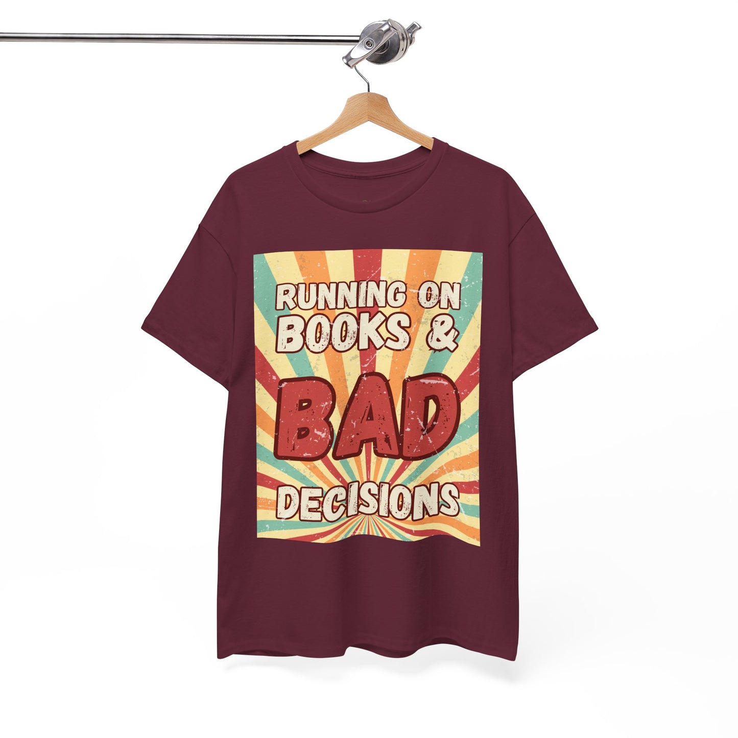 Maroon t-shirt with colorful retro burst strip graphic and text 'Running on Books & Bad Decisions' 