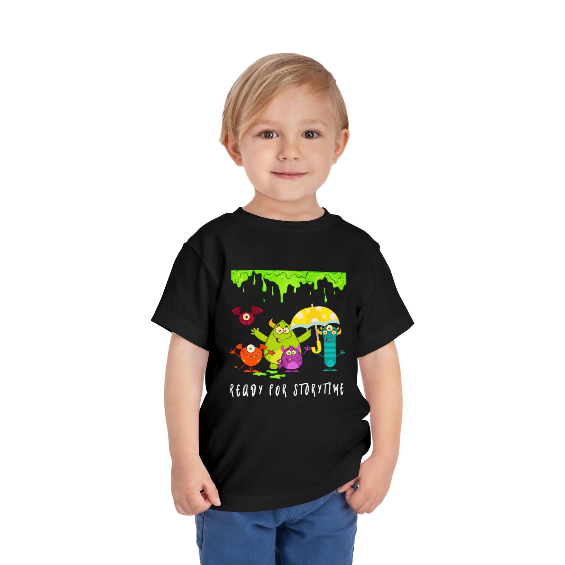 Child wearing a black toddler t-shirt with colorful monster characters, an umbrella and green dripping slime, 'Ready for Storytime' text 