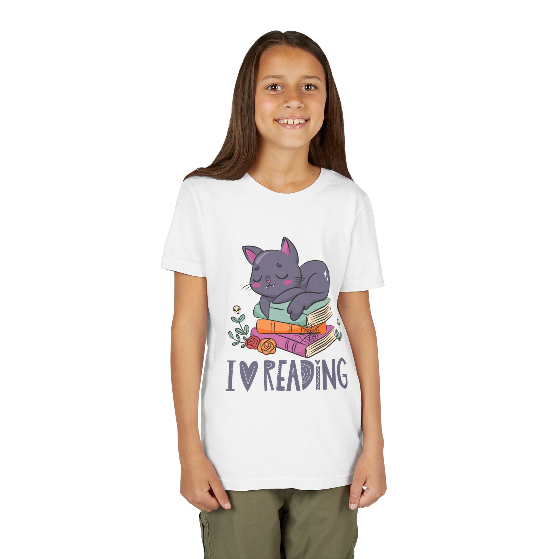 Girl wearing a white t-shirt with a cat snoozing on a stack of books and 'I love reading' text 