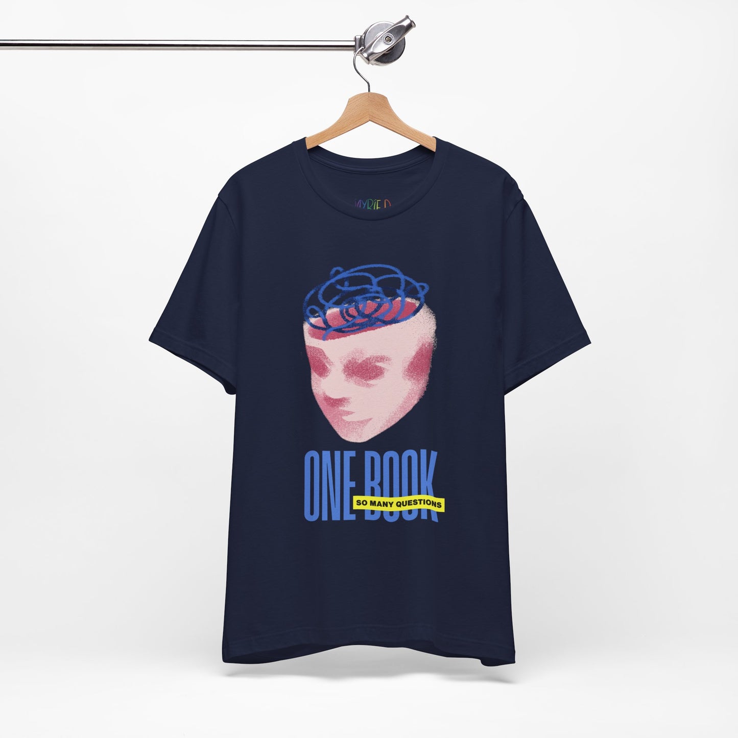 Navy t-shirt with a pink face/head graphic, blue swirls coming out of the top and text 'One Book So Many Questions'