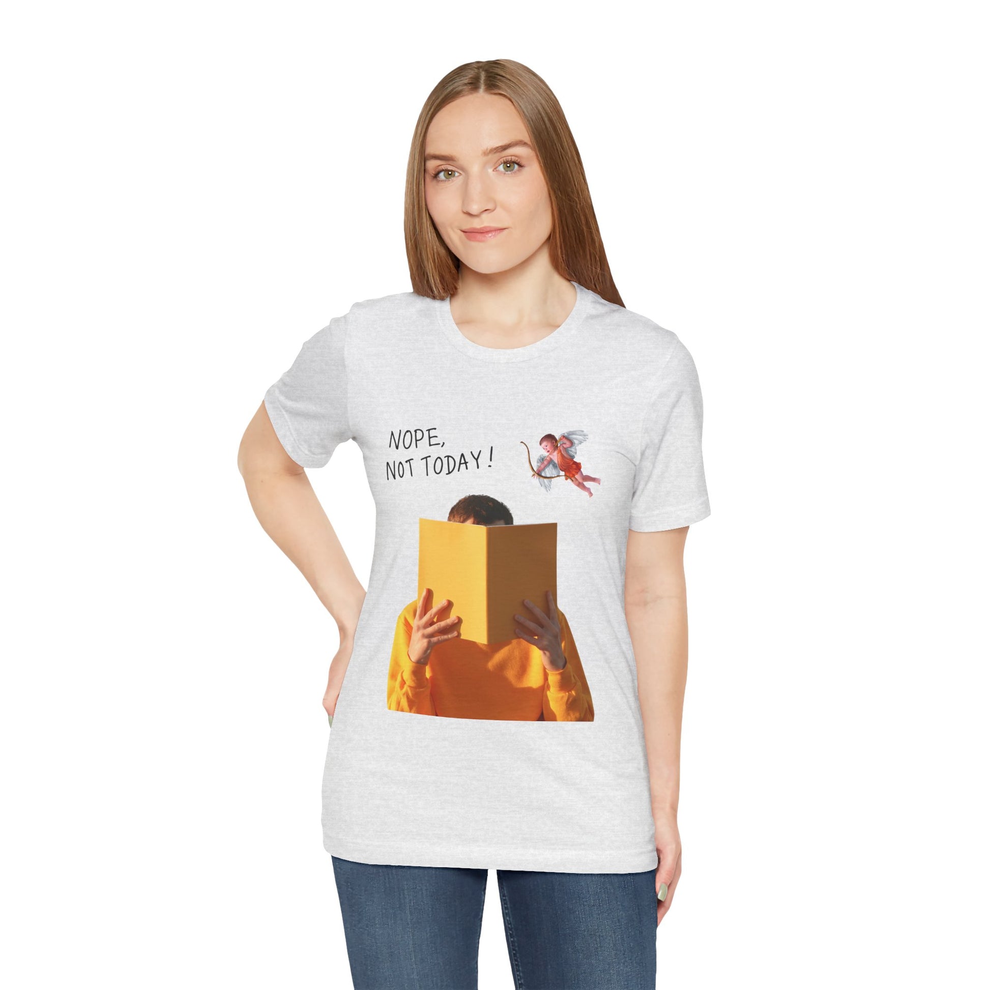 Woman wearing an ash t-shirt with graphic design of person holding a book in front of their face while cupid is hovering above and text 'NOPE, NOT TODAY!' 