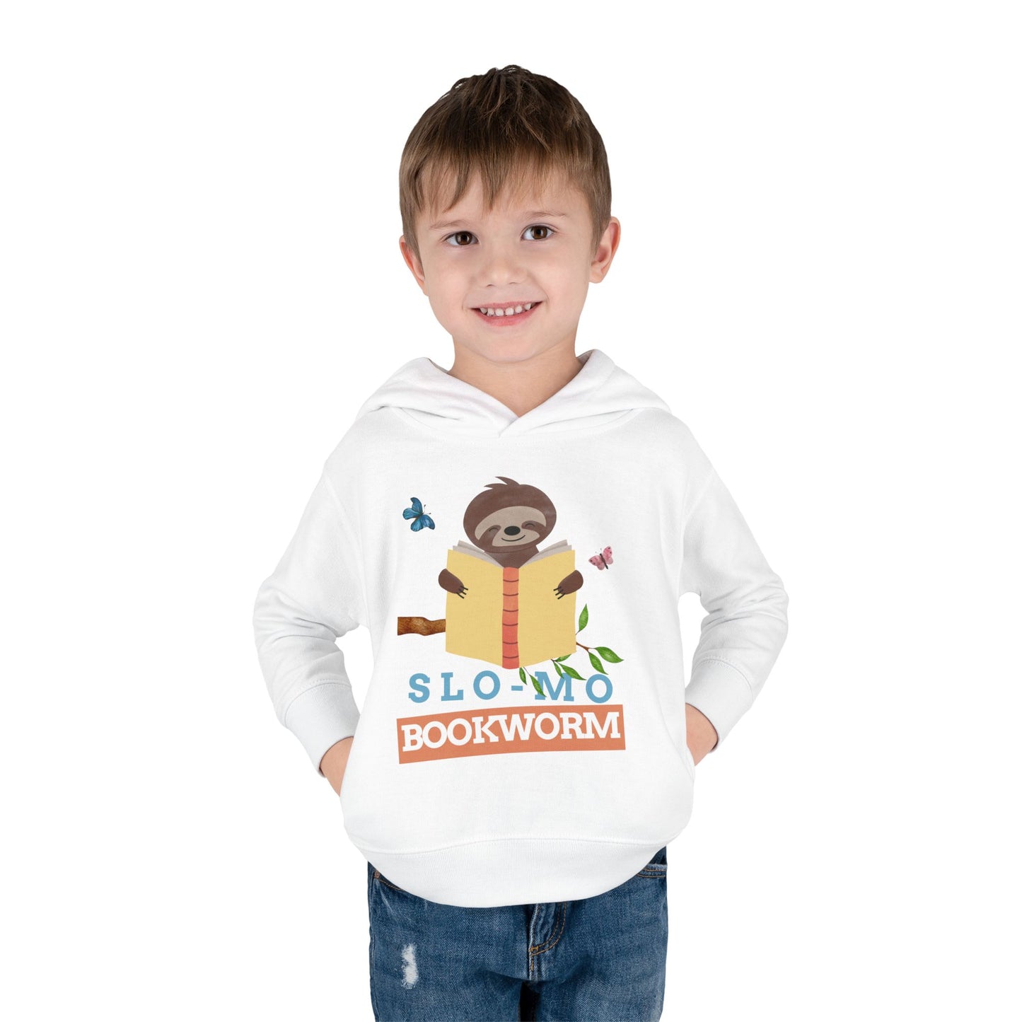 Boy wearing a white toddler hoodie with a sloth reading a book graphic and 'SloMo Bookworm' text 