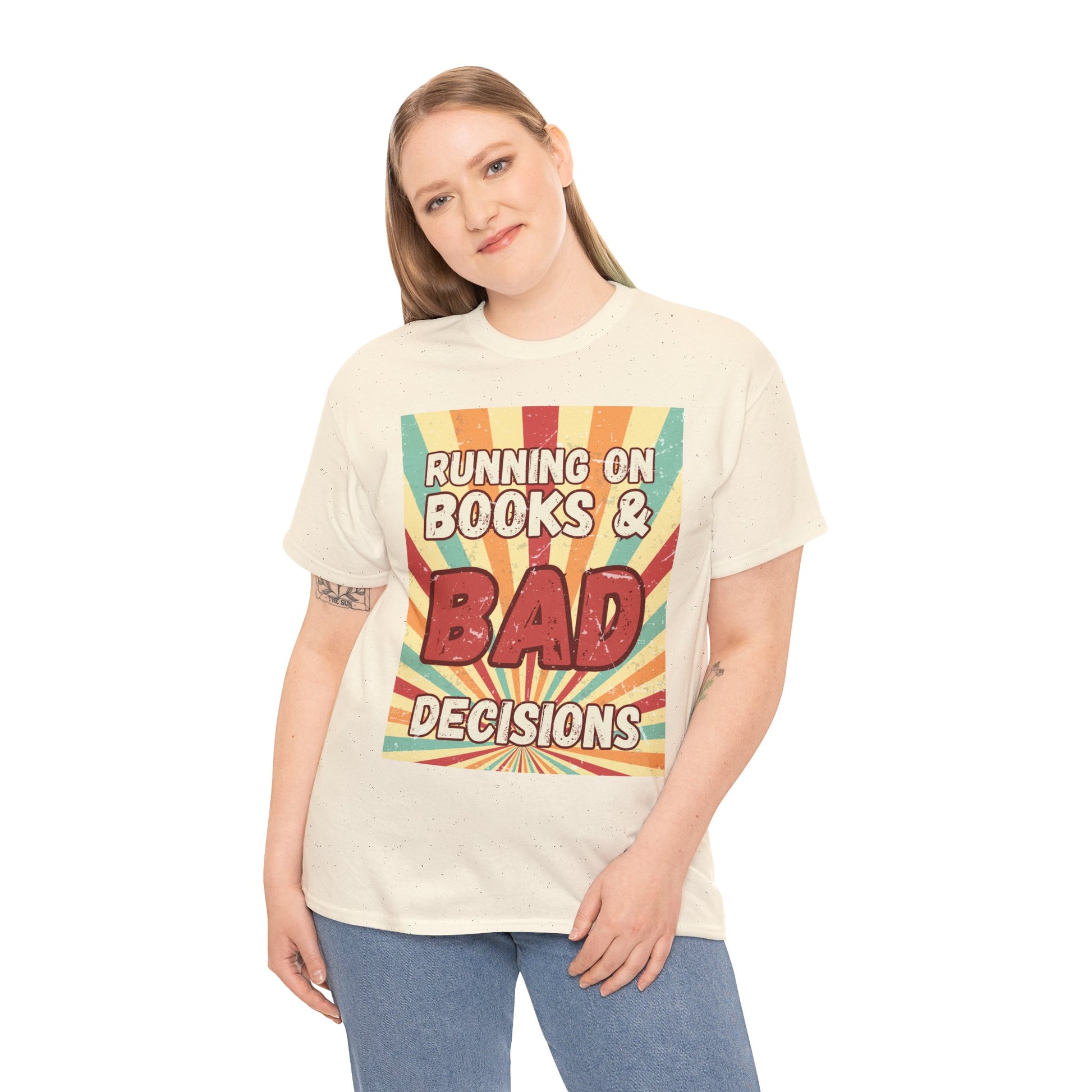 Woman wearing a beige t-shirt with colorful retro burst strip graphic and text 'Running on Books & Bad Decisions' 