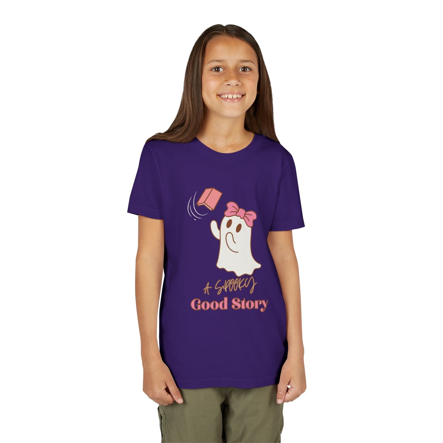 Girl wearing a purple t-shirt with ghost trying to catch a haunted book and text 'A Spooky Good Story'