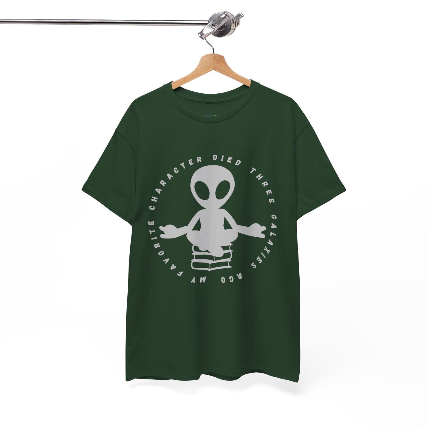 Dark green t-shirt with meditating alien sitting on a stack of books, circled by text 'My Favorite Character Died Three Galaxies Ago' 