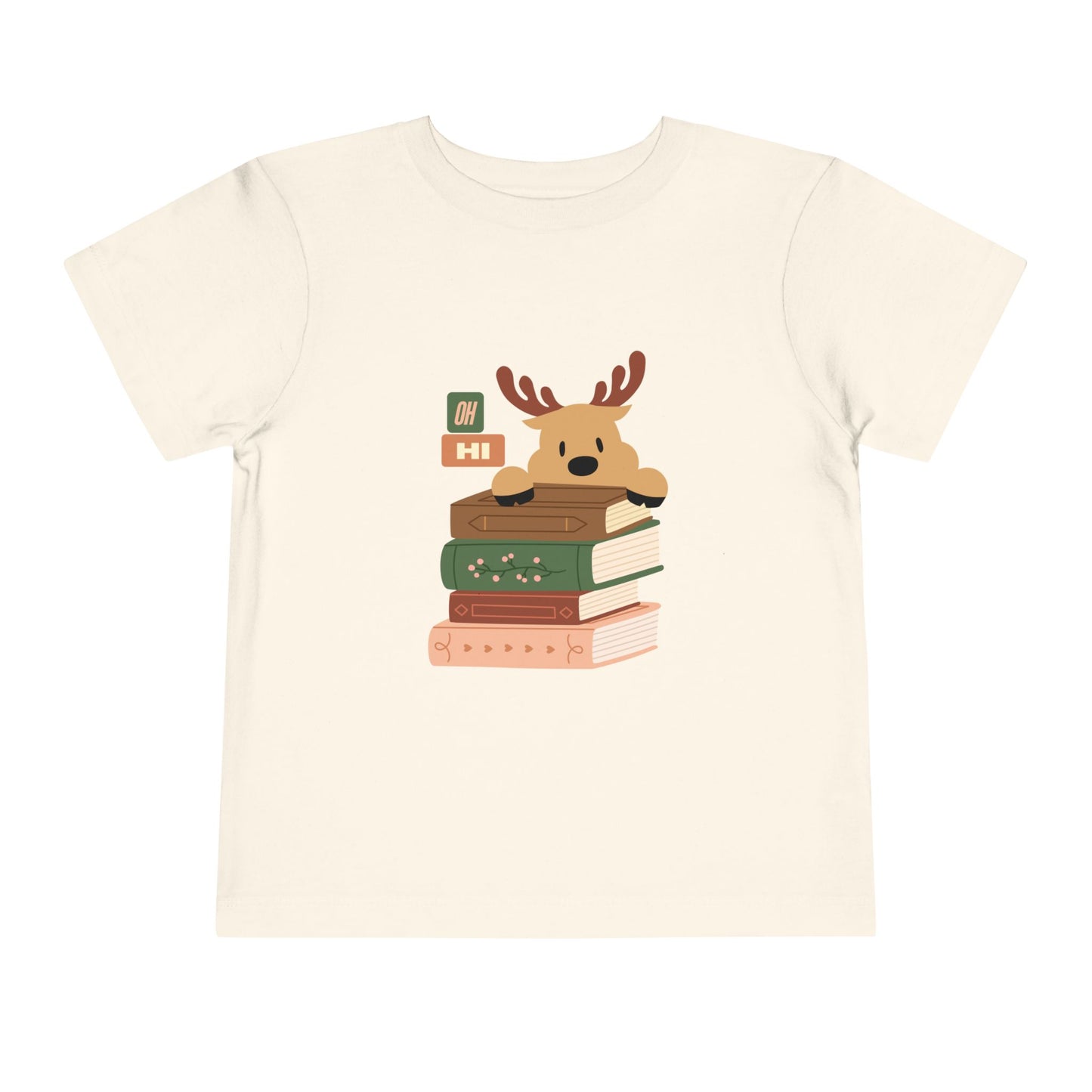 Beige toddler t-shirt with a cartoon reindeer peeking over a stack of books, text 'oh hi', on a white background