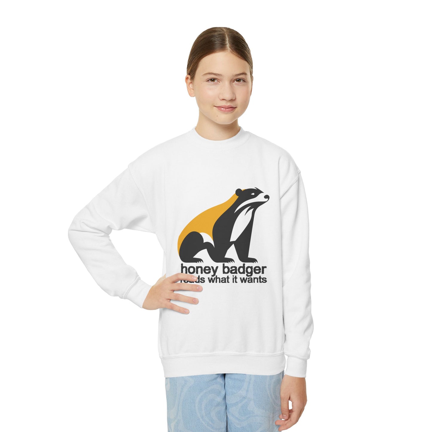 Girl wearing a white sweatshirt with honey badger graphic and text 'honey badger reads what it wants'