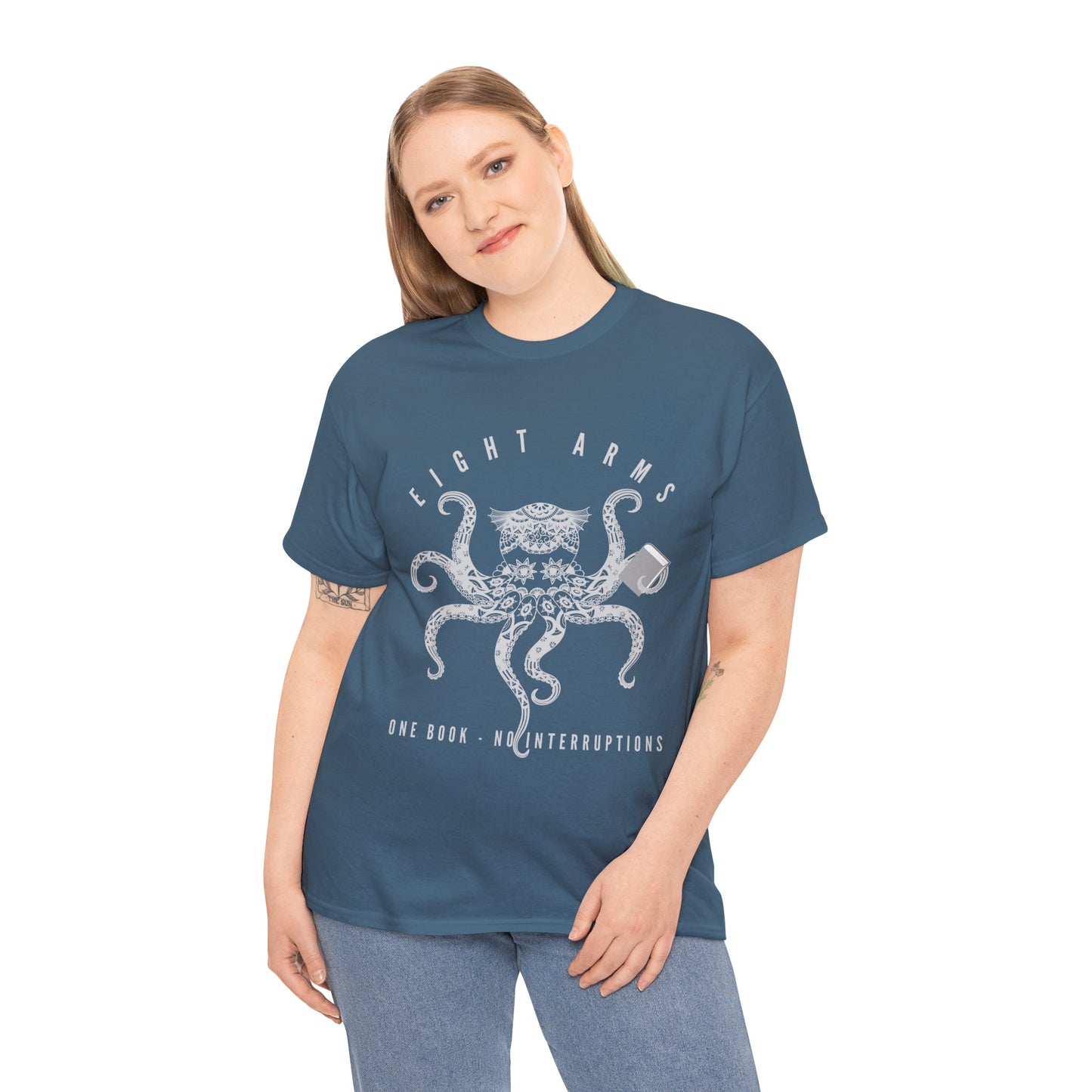 Woman wearing a teal t-shirt with an octopus design holding a book and text 'Eight Arms, One Book, No Interruptions'
