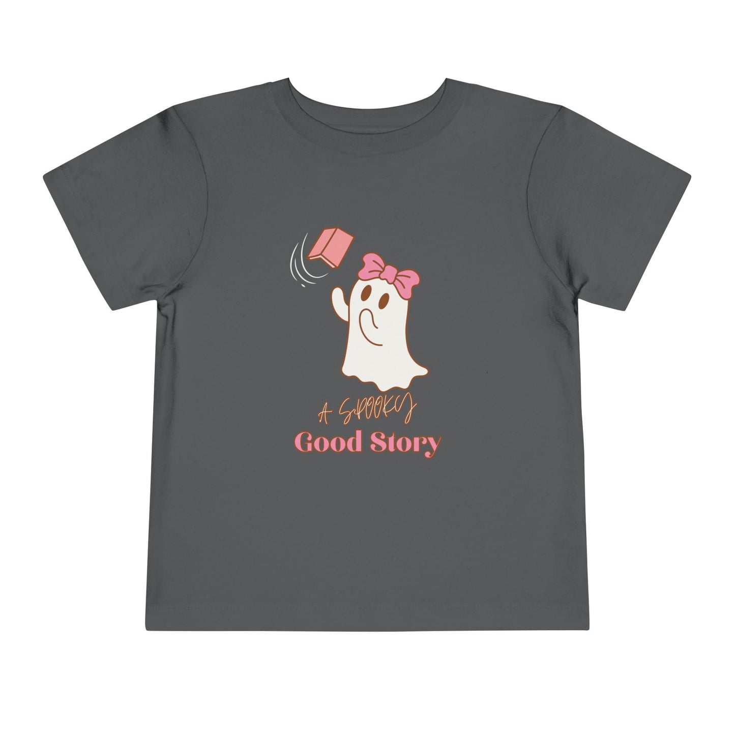Gray toddler t-shirt with a ghost trying to catch a floating pink book with text 'A SPOOKY GOOD STORY'