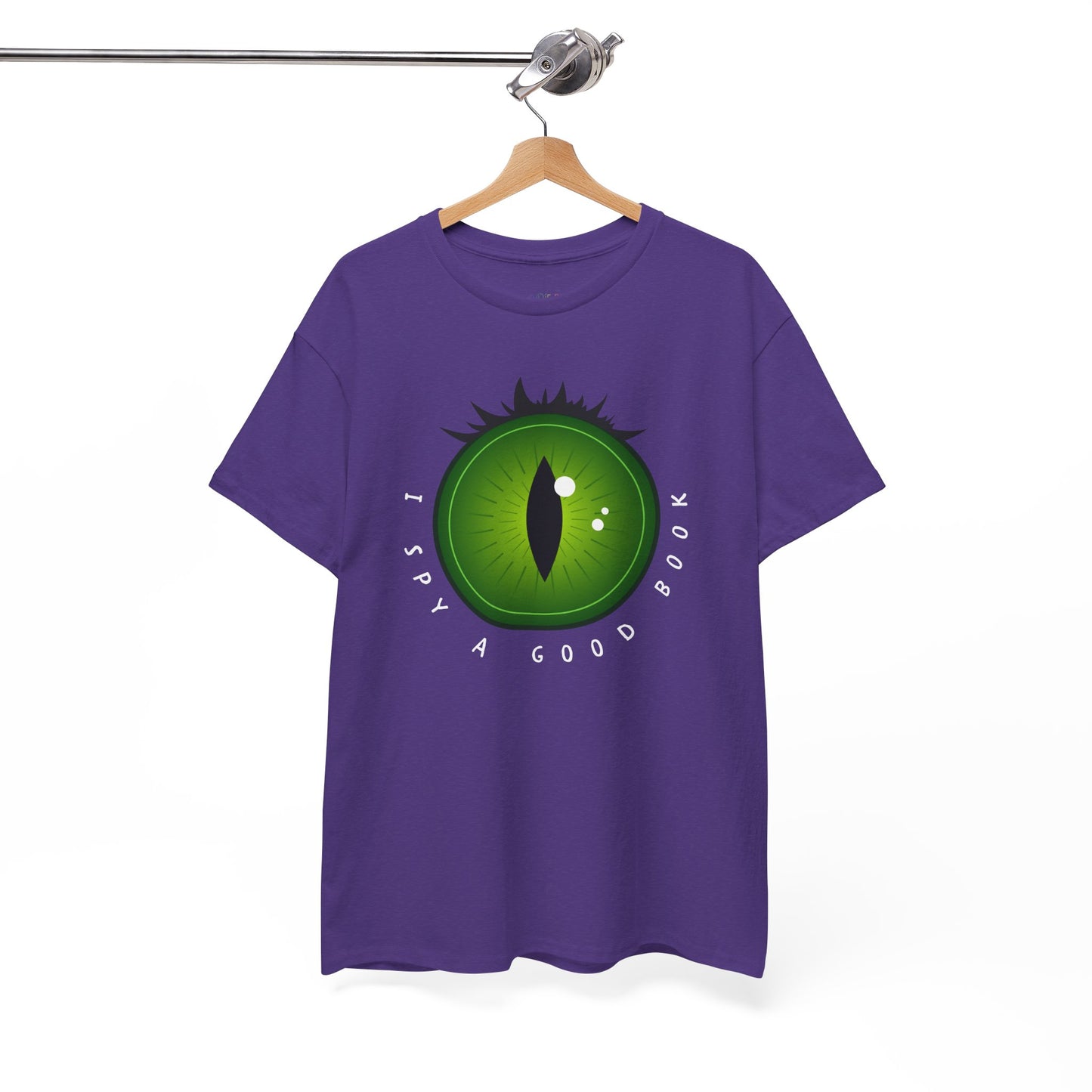 Purple t-shirt with a green eye design and text 'I Spy A Good Book' on a hanger against a white background