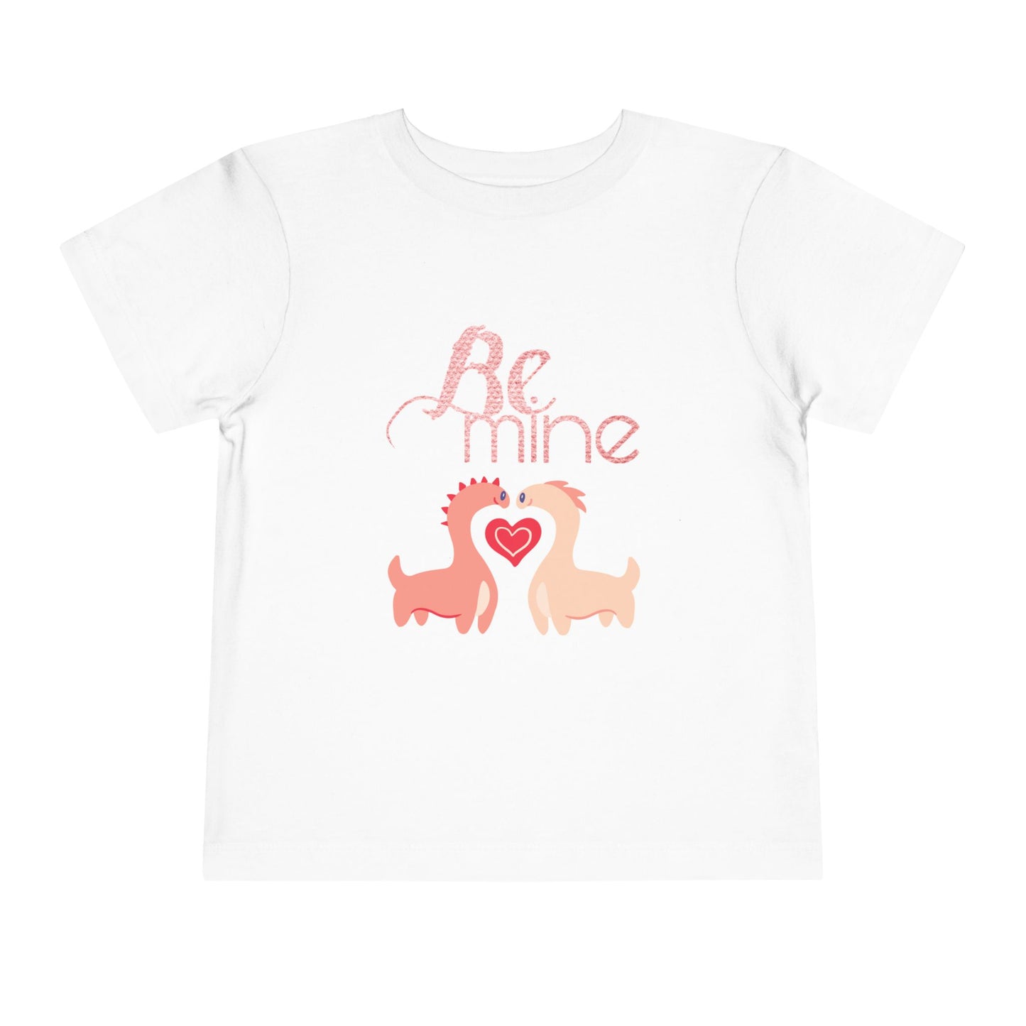 White toddler t-shirt with two pink dinosaurs, a heart and 'Be Mine' text 