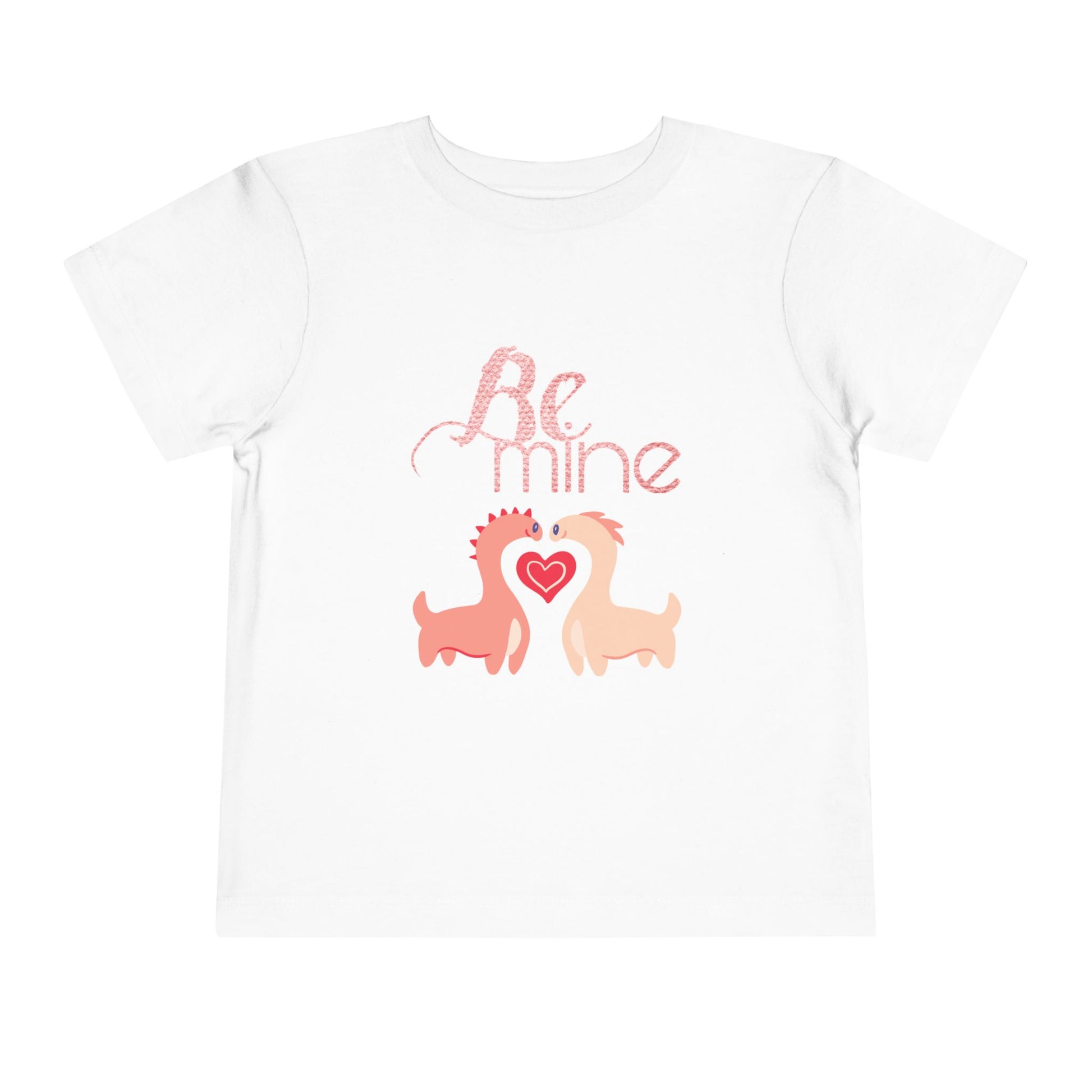 White toddler t-shirt with two pink dinosaurs, a heart and 'Be Mine' text 