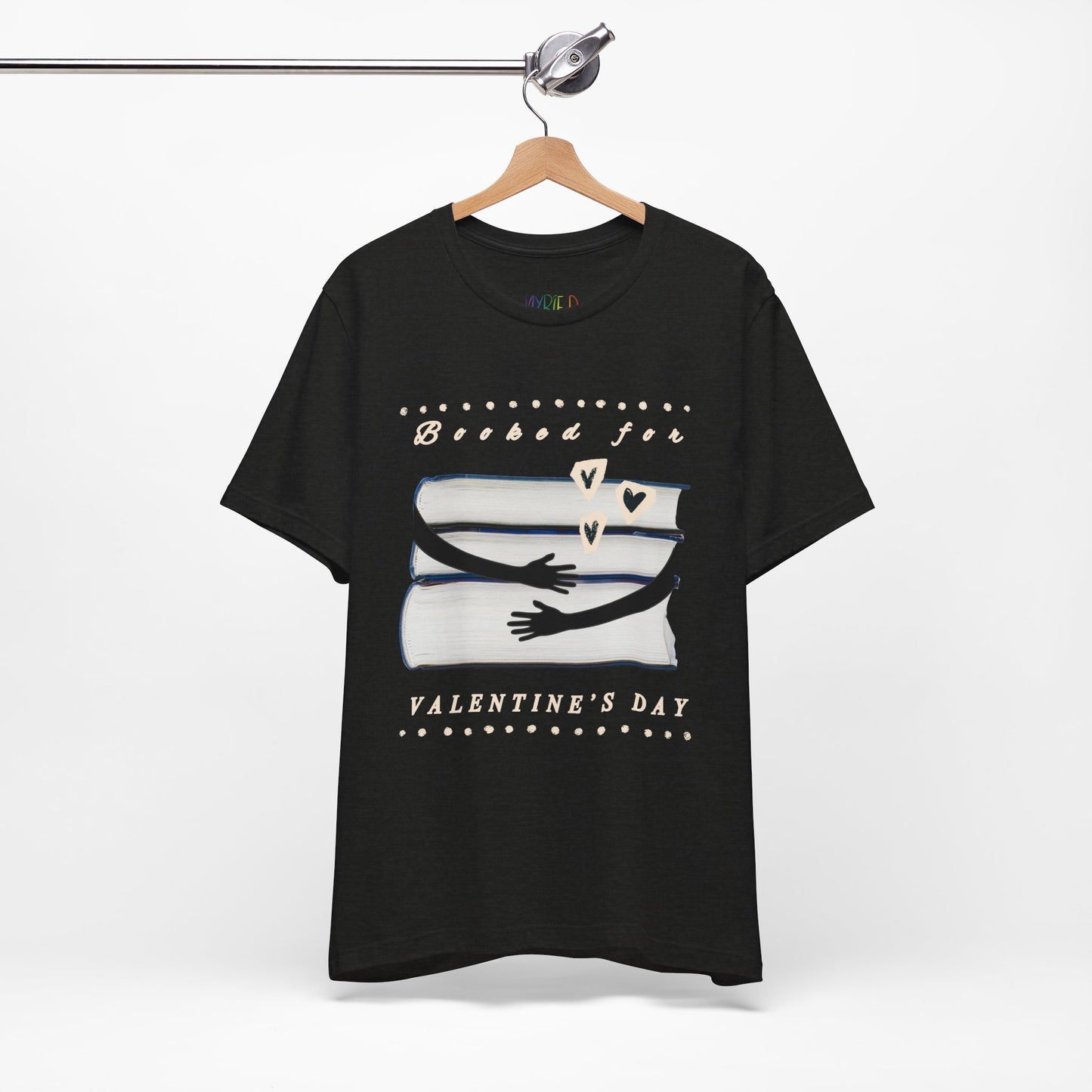 Black t-shirt with a graphic design featuring arms hugging a stack of books and text 'Booked for Valentine's Day' 