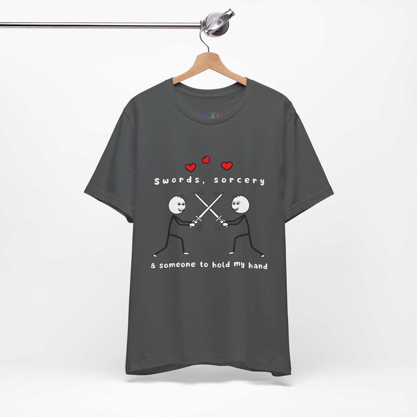 Gray t-shirt with graphic design of two smiling stick figures sword fighting and text 'Swords, Sorcery & Someone To Hold My Hand'